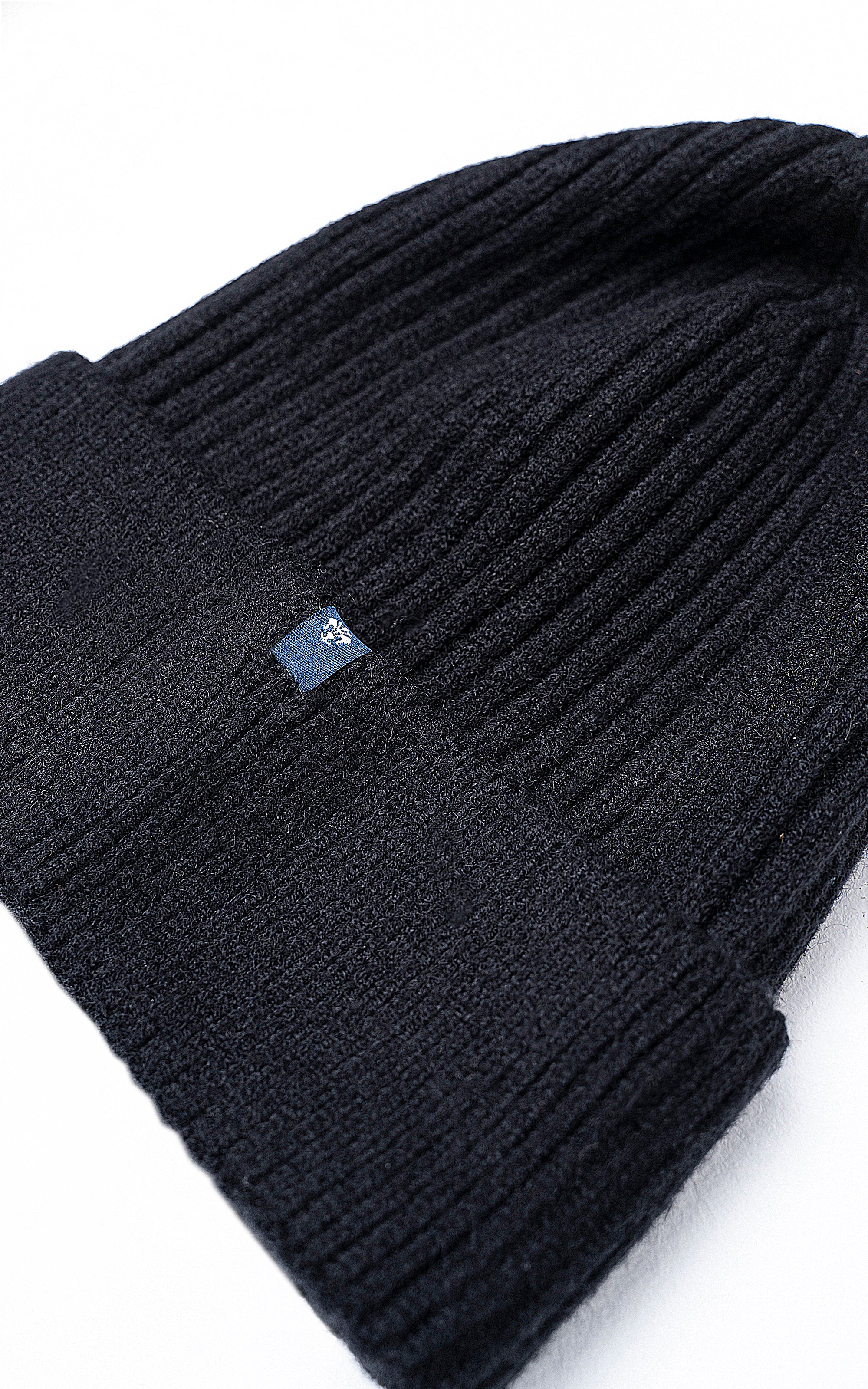 Wool cap knit beanie with small logo patch near the fold