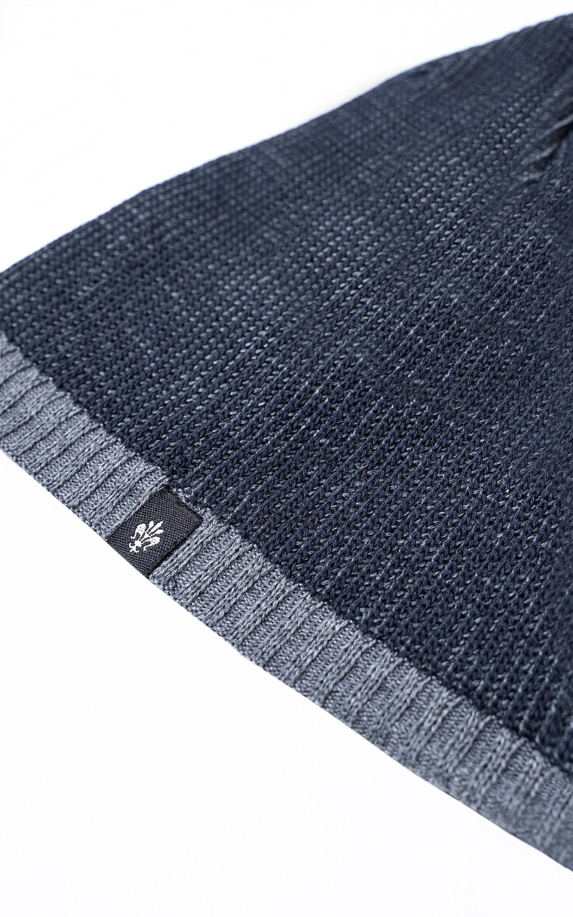 Navy wool cap cuff with knit band and small woven logo patch