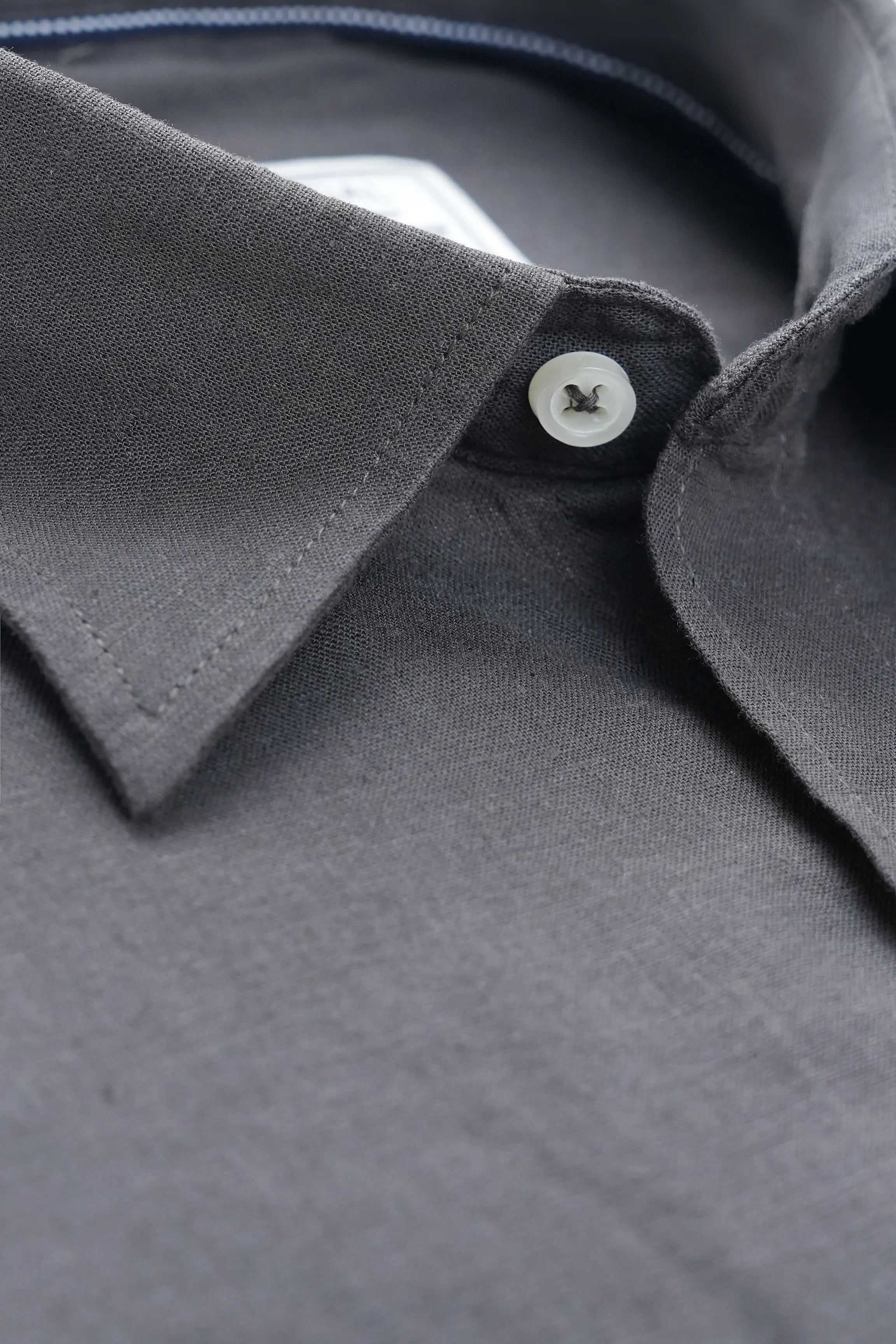 Black linen shirt collar with button detail and contrast inner facing