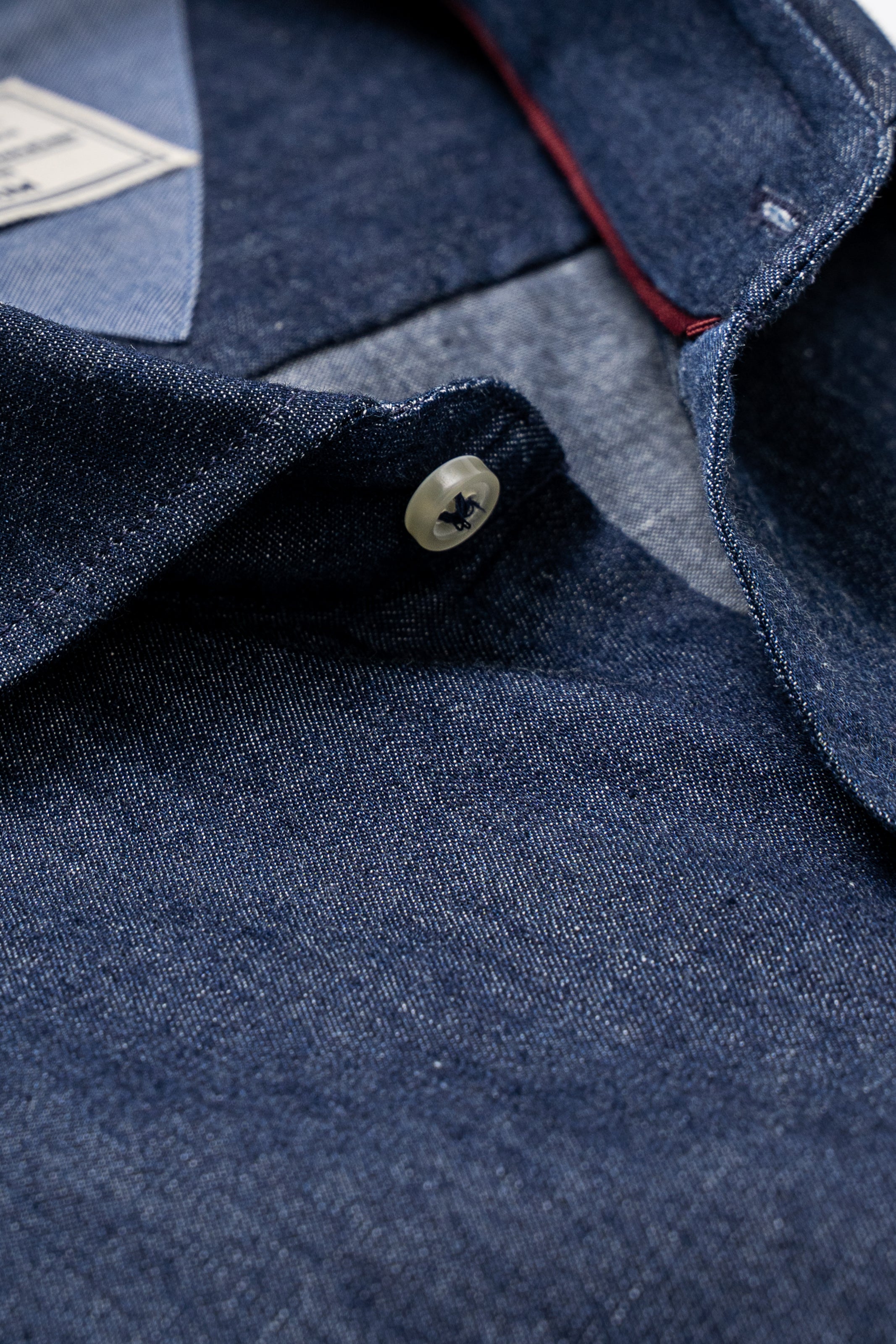 Denim shirt close-up of button placket and pocket stitching