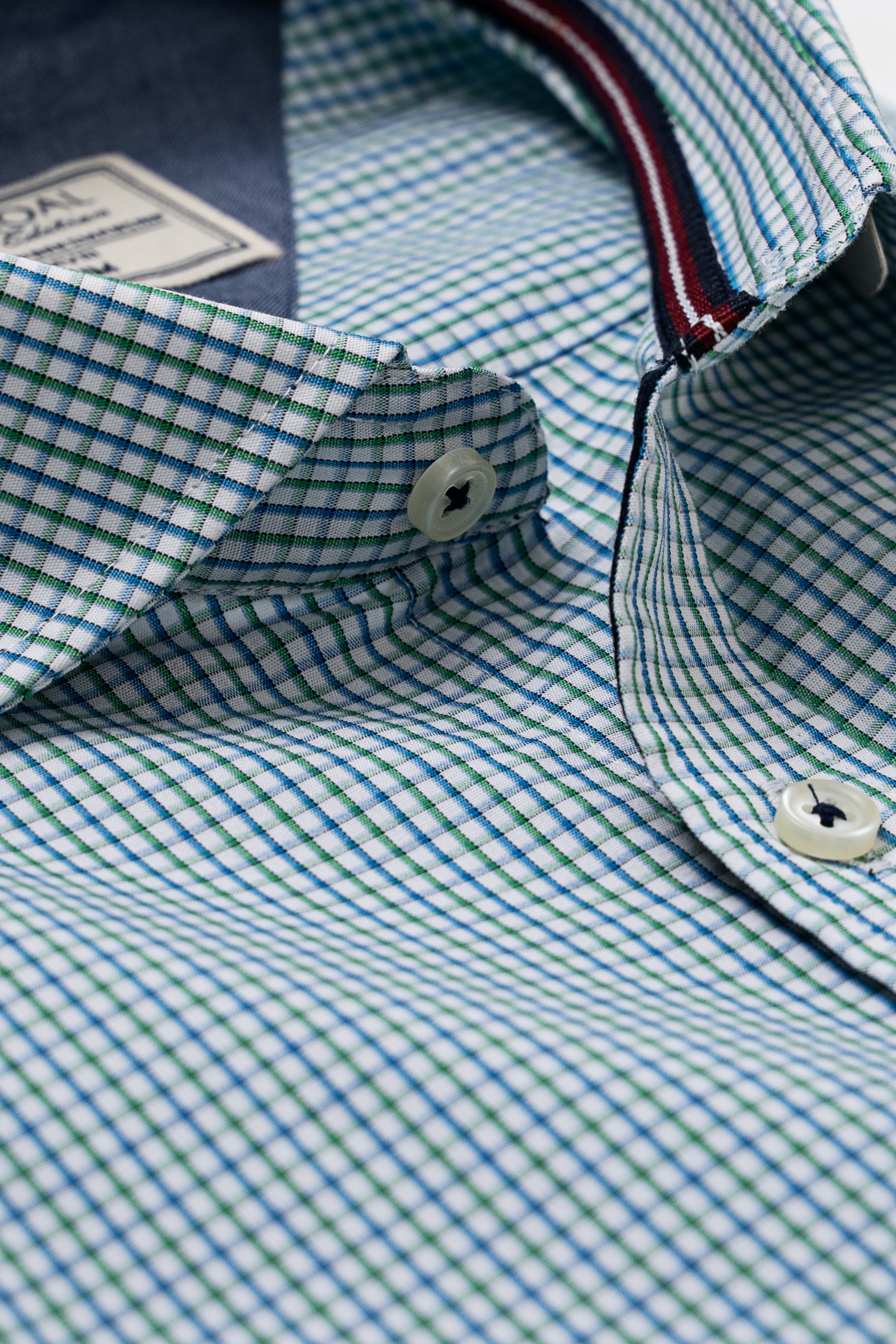 Limited edition blue-green check shirt collar and button placket close-up