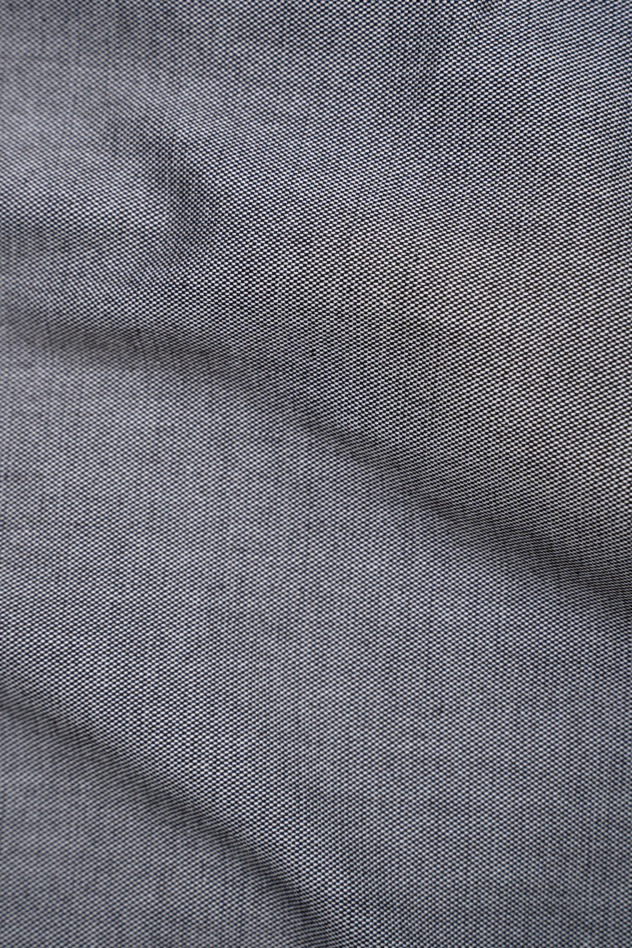 Mid grey shirt fabric close-up with fine woven texture