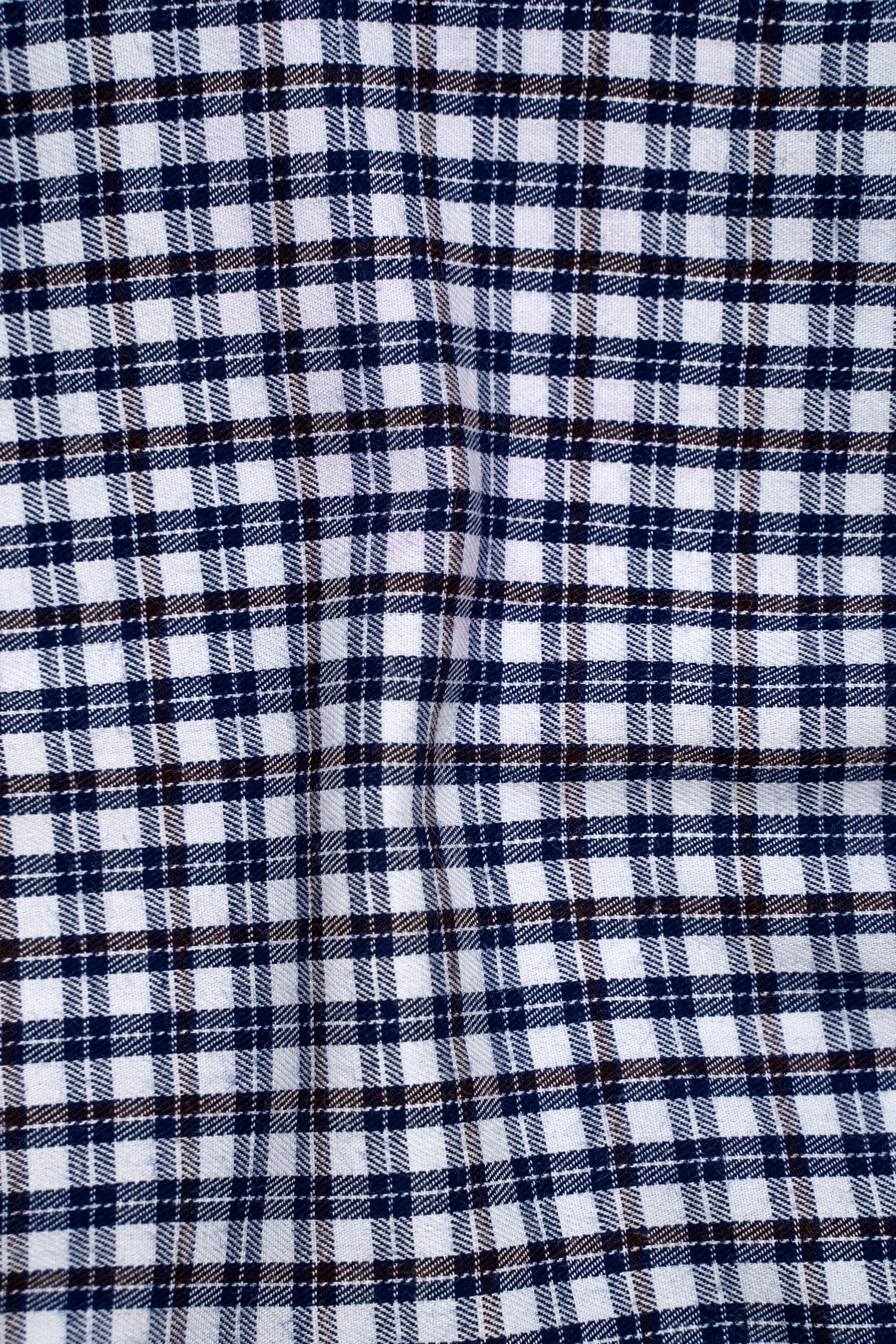 Blue and white plaid check fabric pattern on a shirt front