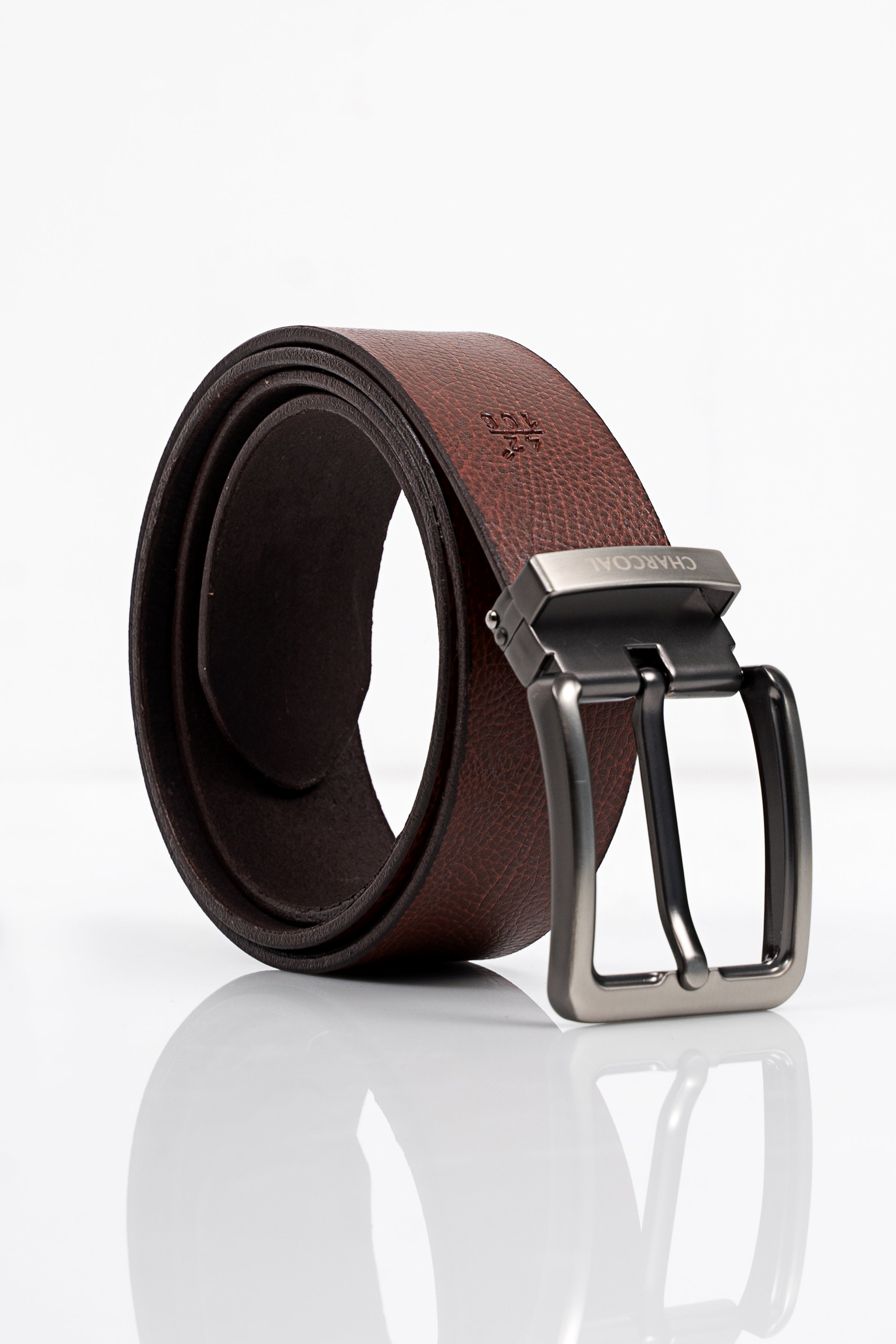 Brown leather belt with silver metal buckle, stitched edge, and keeper loop detail