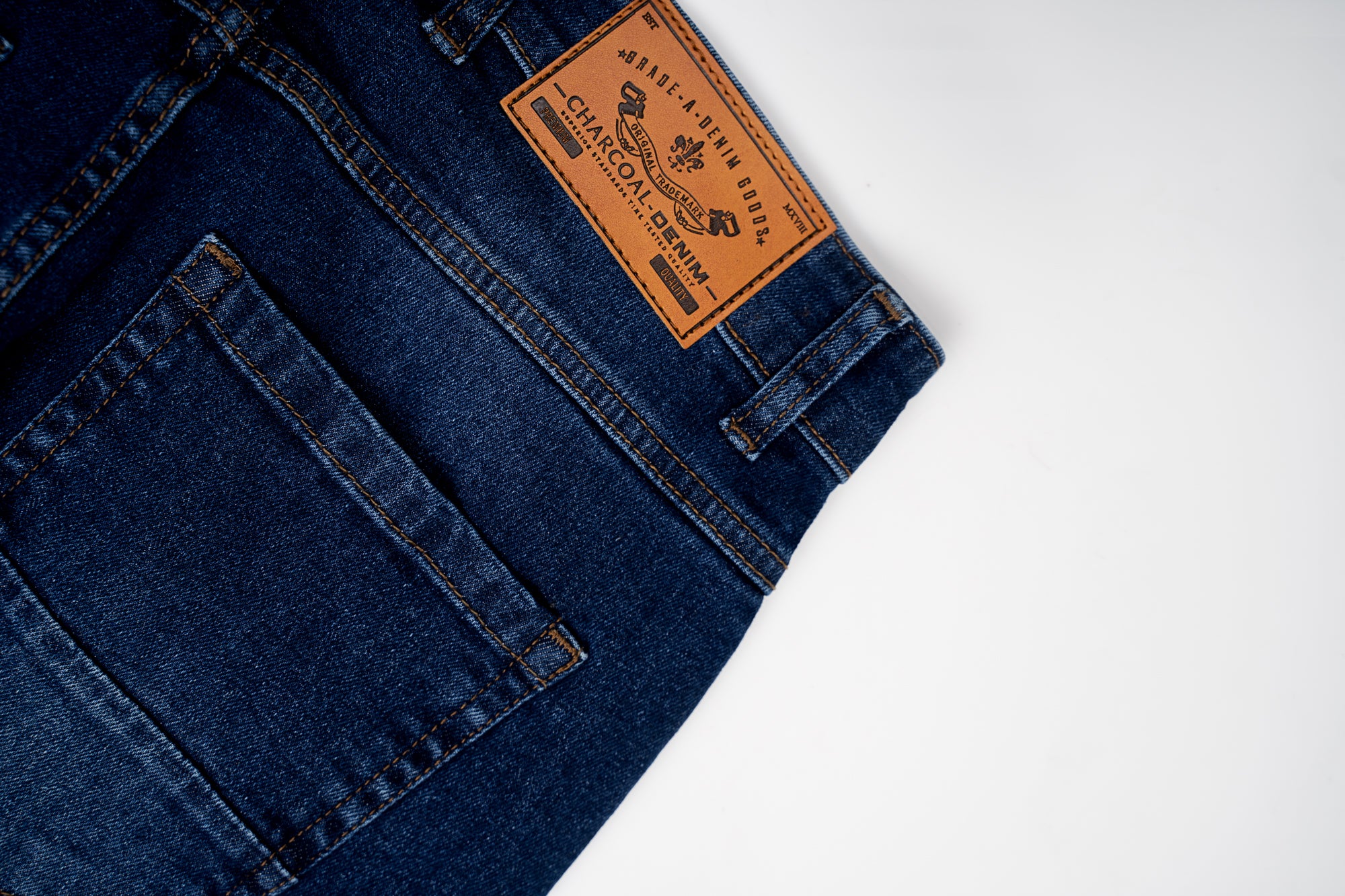 Mid blue denim jeans with brand patch on back yoke and stitched back pocket