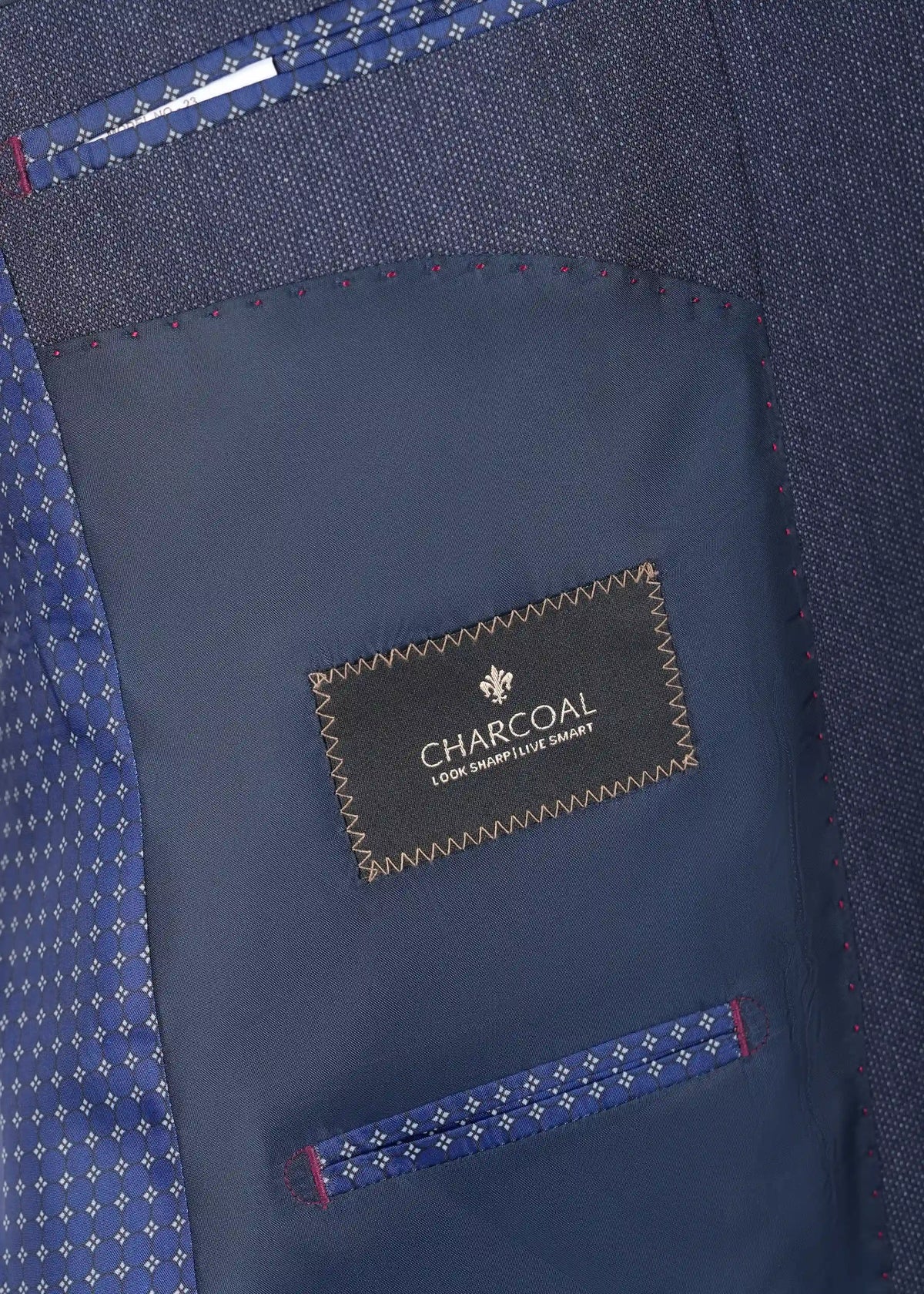 Teal blue suit inner lining with CHARCOAL label and decorative stitched edges.