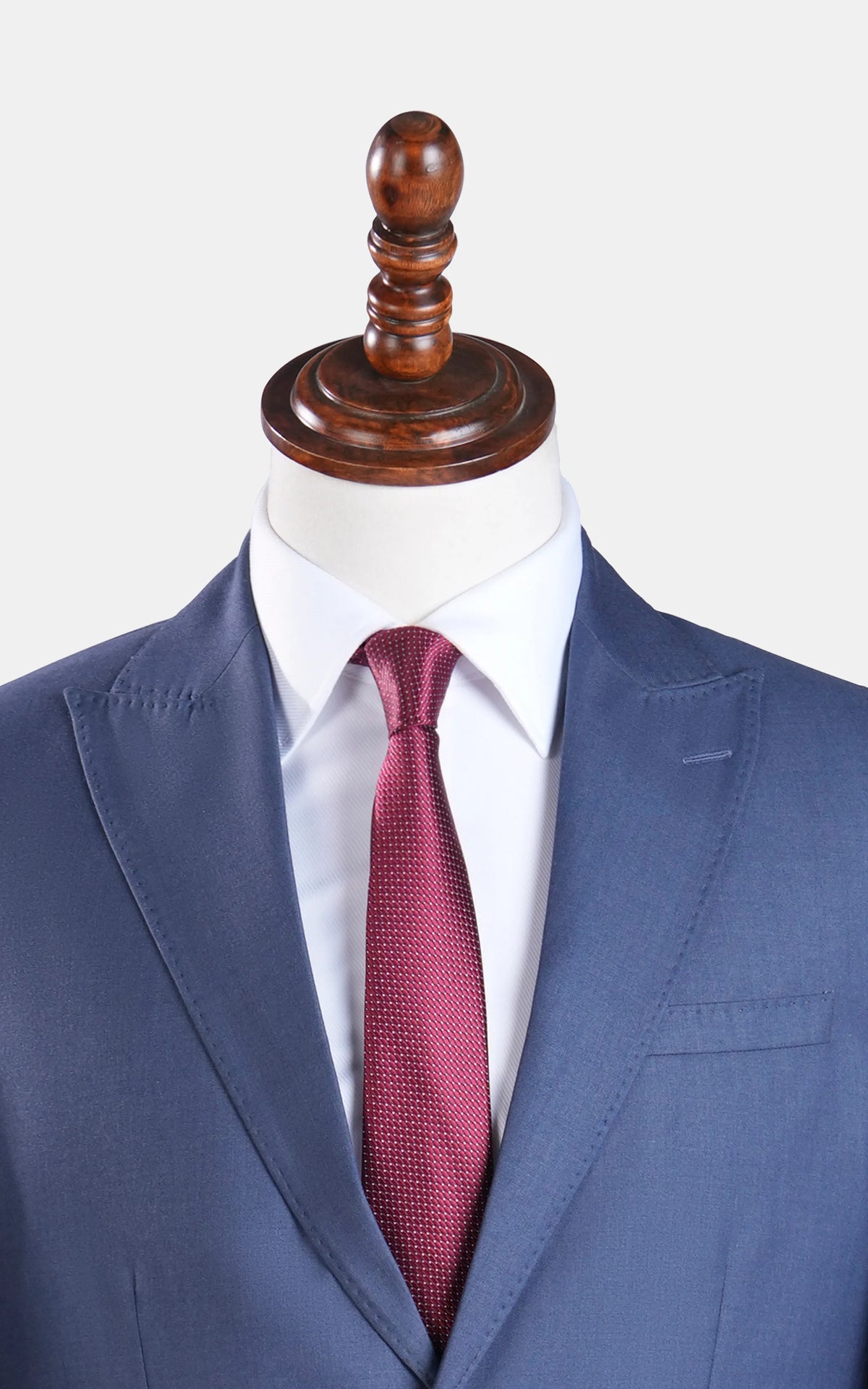 Bluish grey suit jacket with red patterned tie, close-up on neckline.