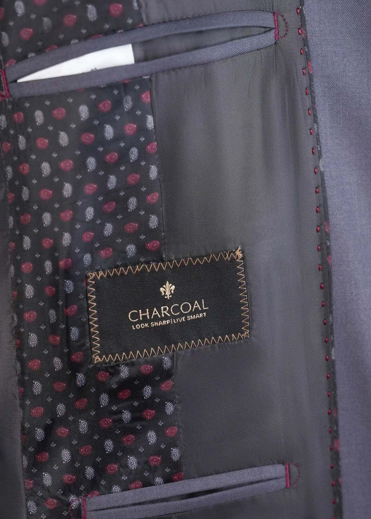 Suit lining interior with charcoal label and red-stitched pocket edging