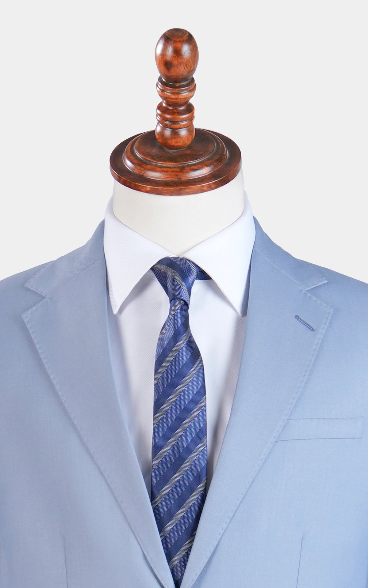 Smoke blue suit jacket with notch lapel and striped tie