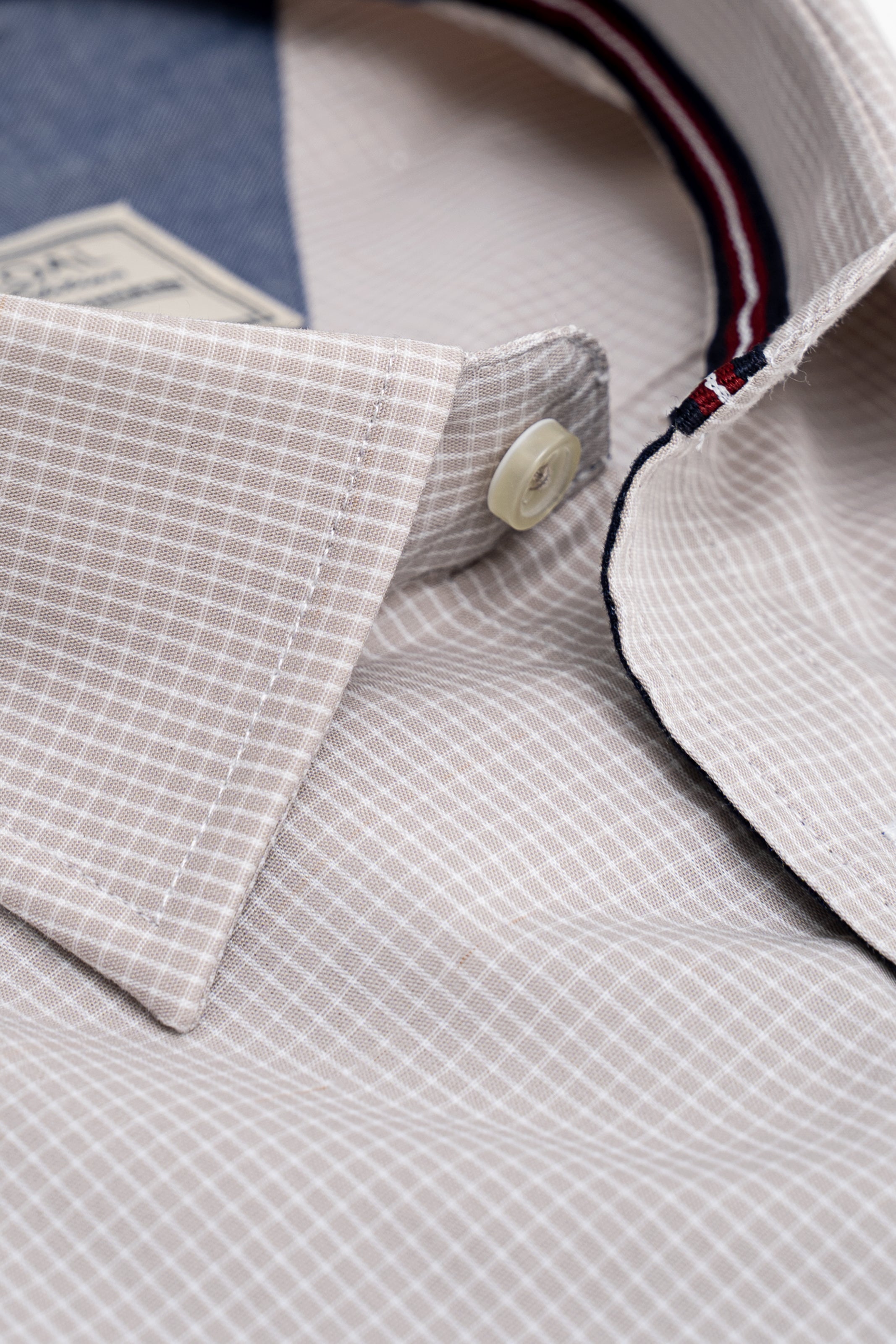 Light khaki check dress shirt cuff with round buttons and inner collar trim