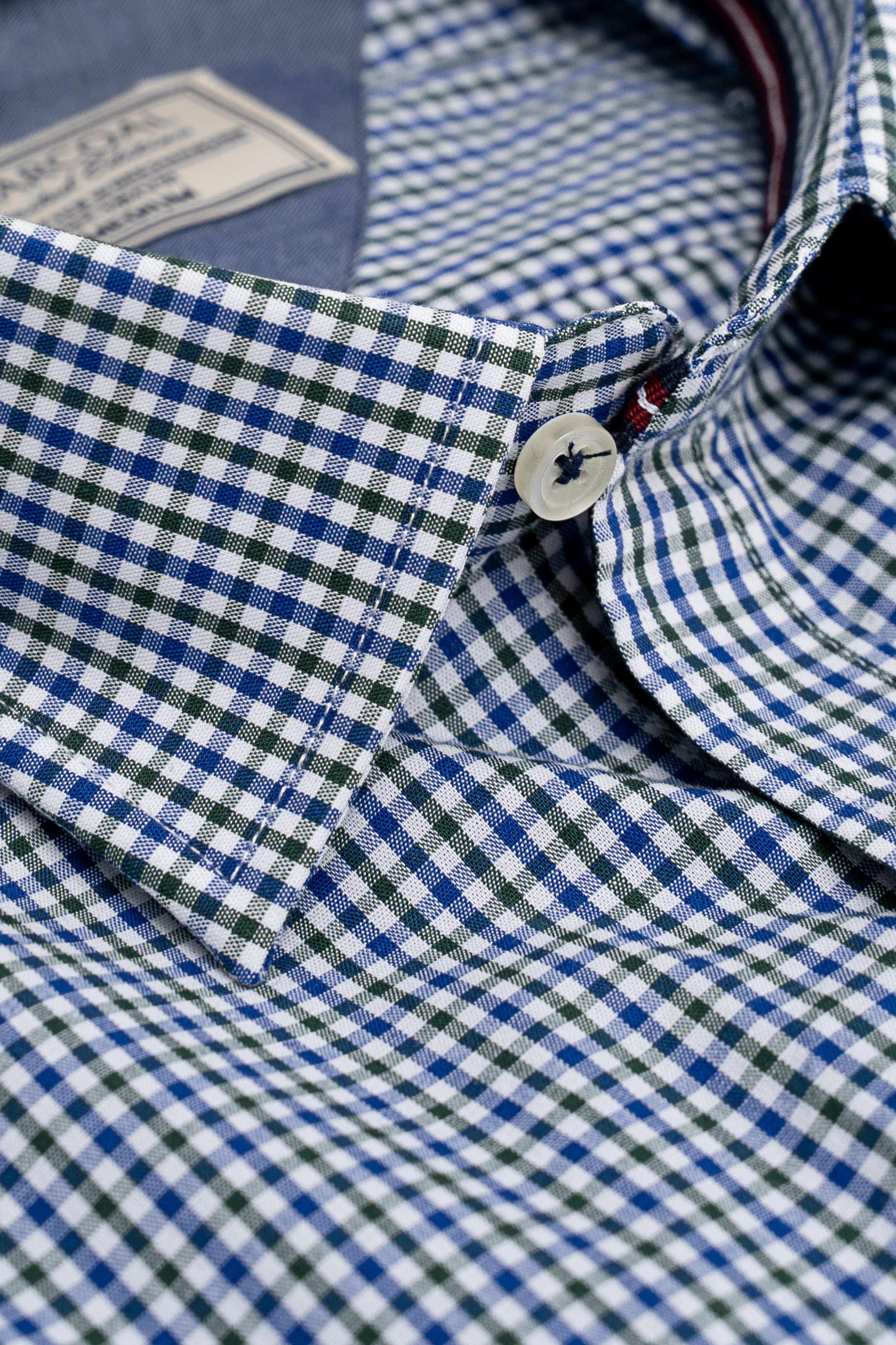 Blue green check shirt collar with white buttons and stitched placket