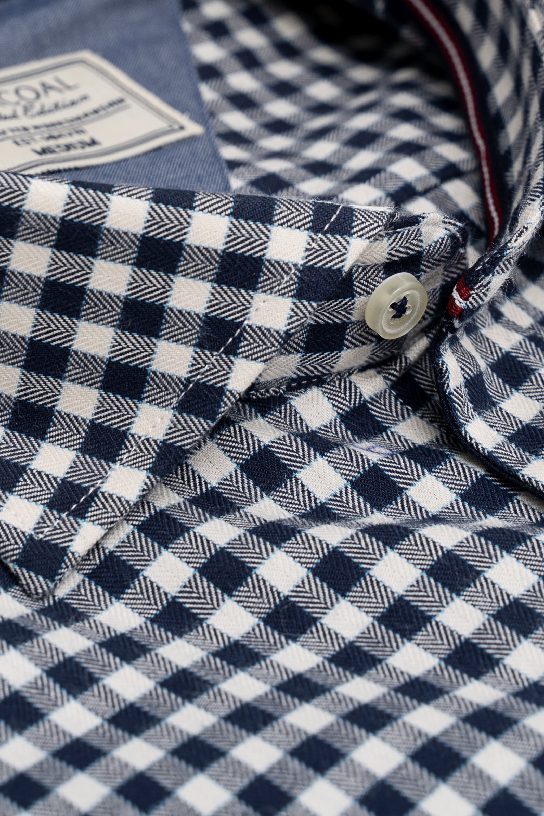 Blue and white check shirt fabric with round buttons on the placket
