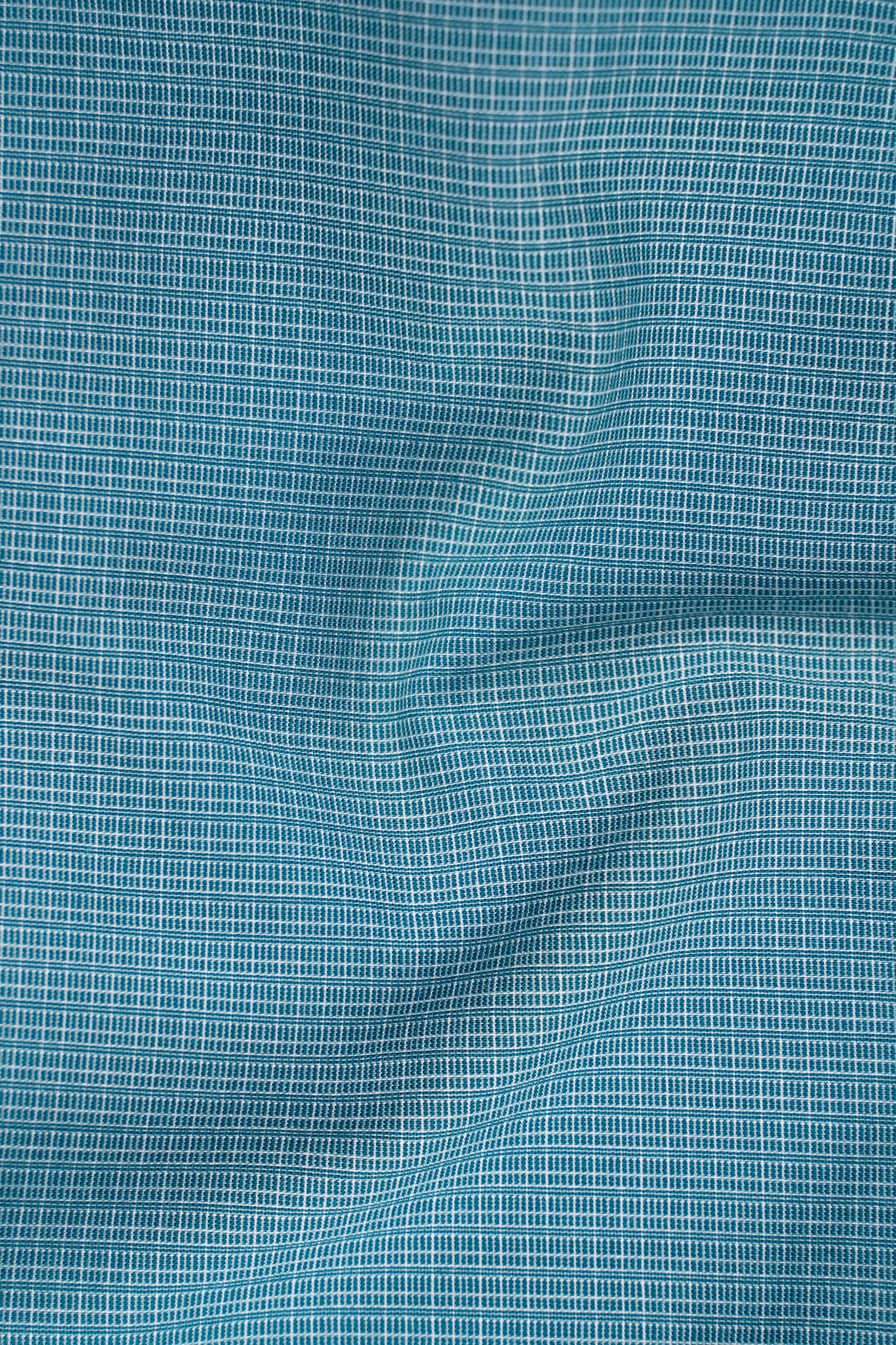 Aqua green woven shirt fabric with fine grid texture