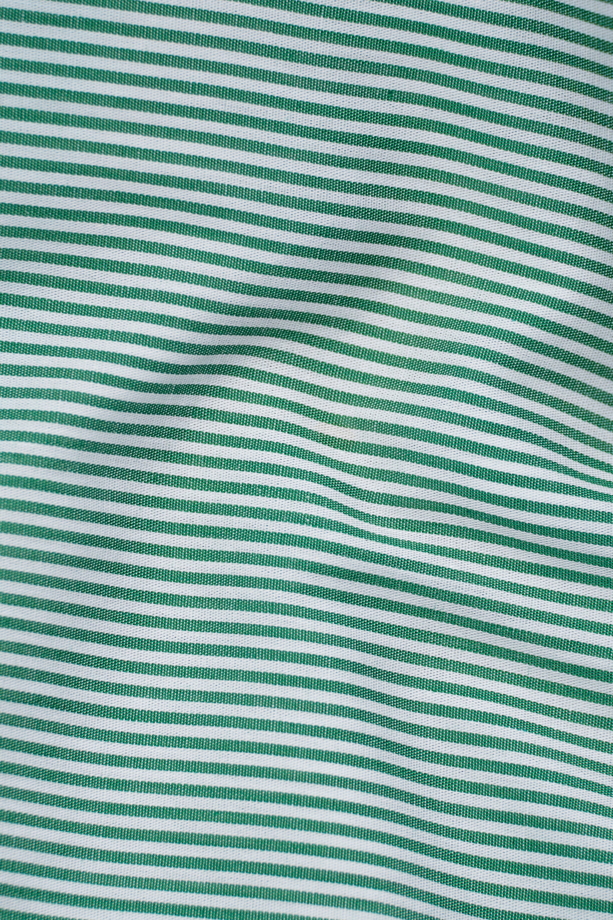 Green-and-white striped shirt fabric with fine vertical pinstripes