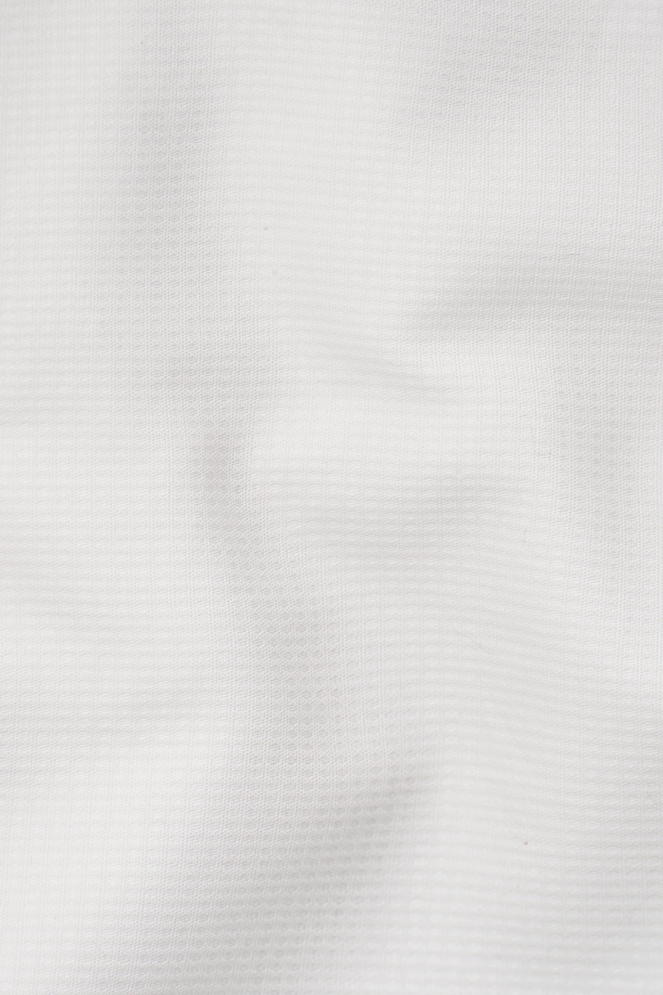White shirt fabric texture close-up with fine woven pattern
