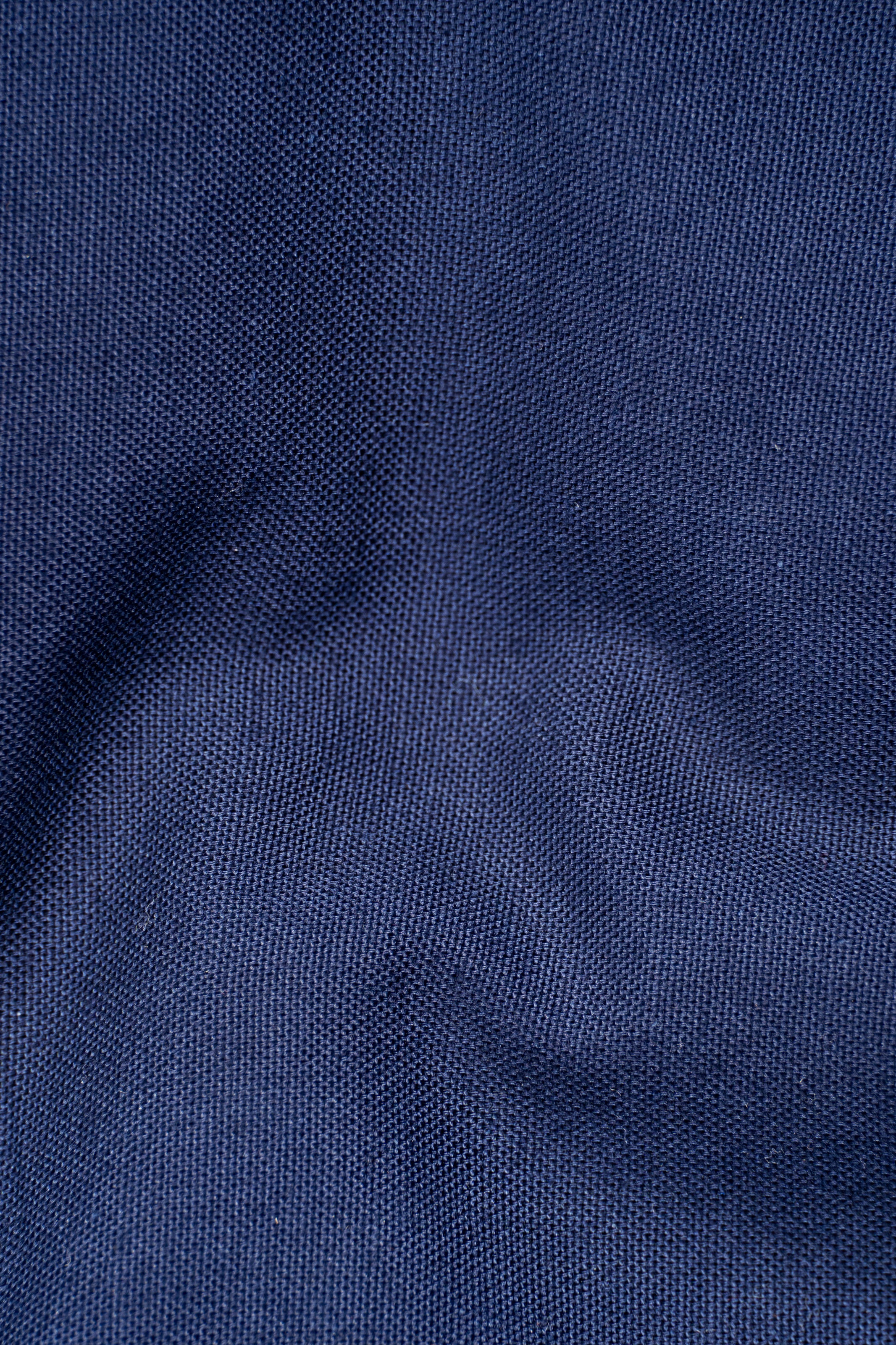 Dark navy shirt fabric close-up with fine woven texture