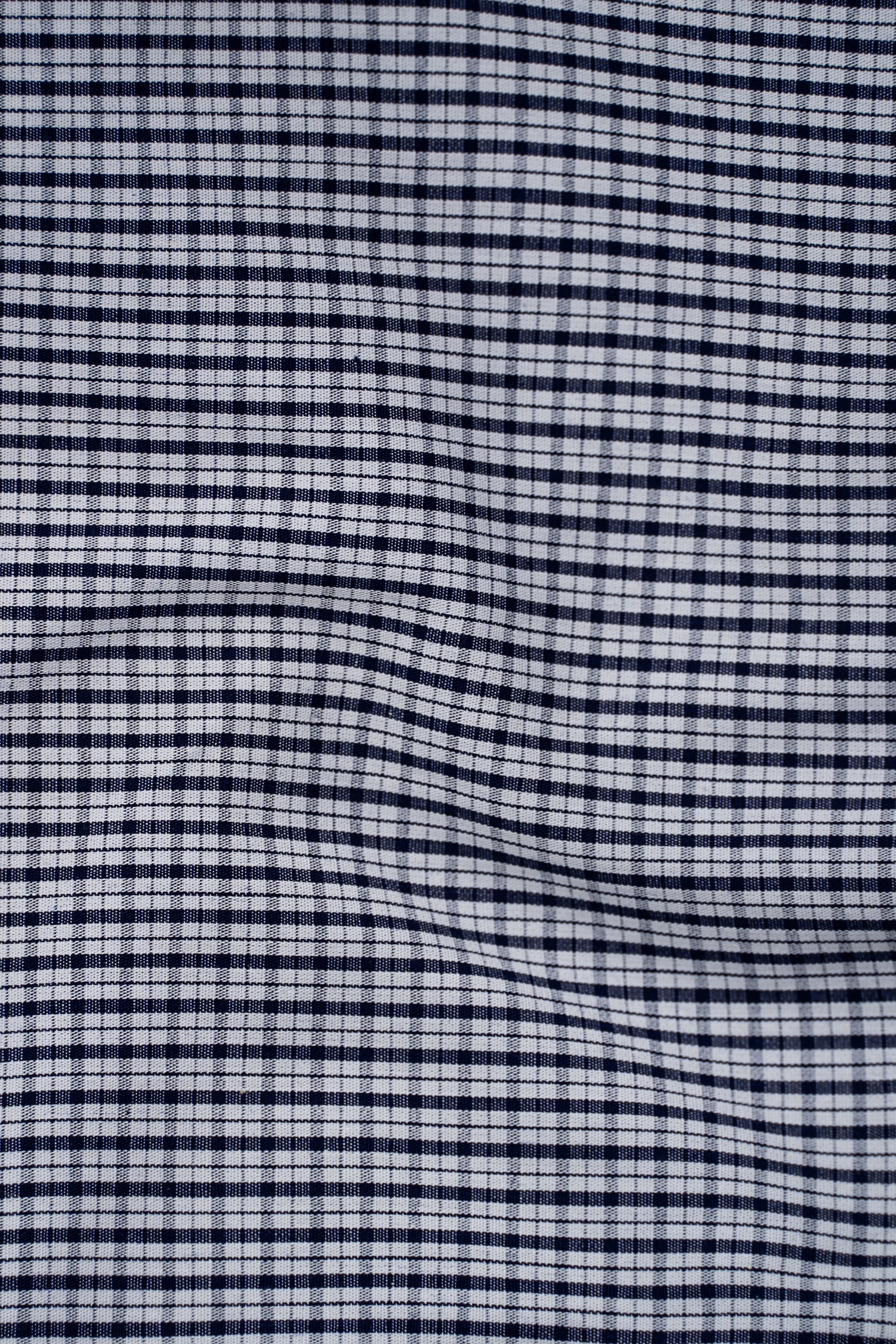 Navy and white checked dress shirt fabric pattern close-up