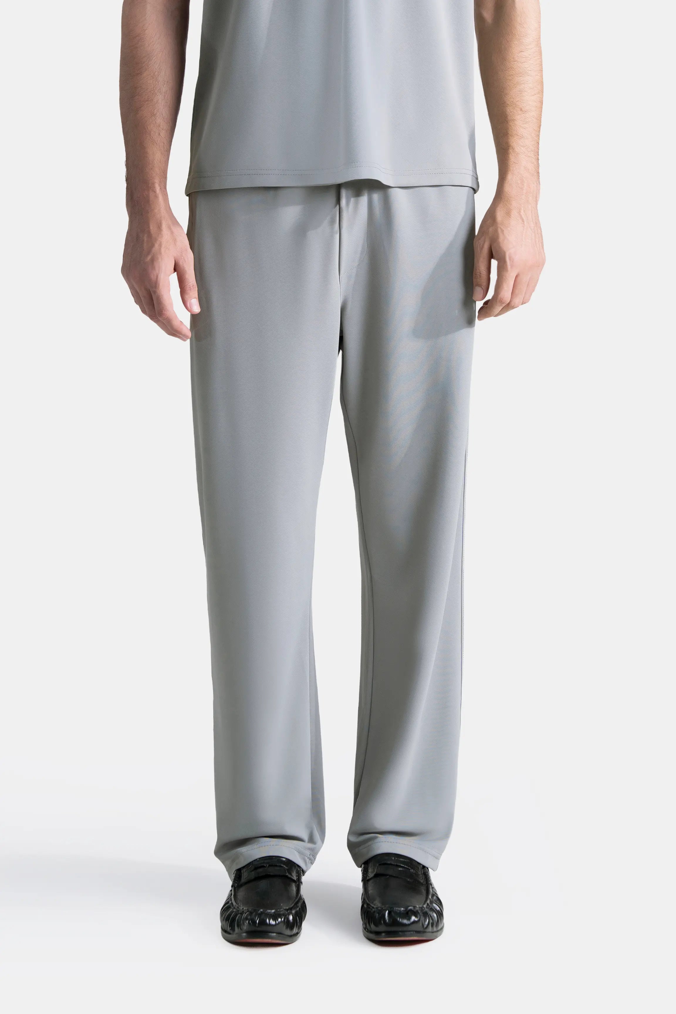Grey loose-fit trousers with elasticated waistband, straight wide-leg, full length.