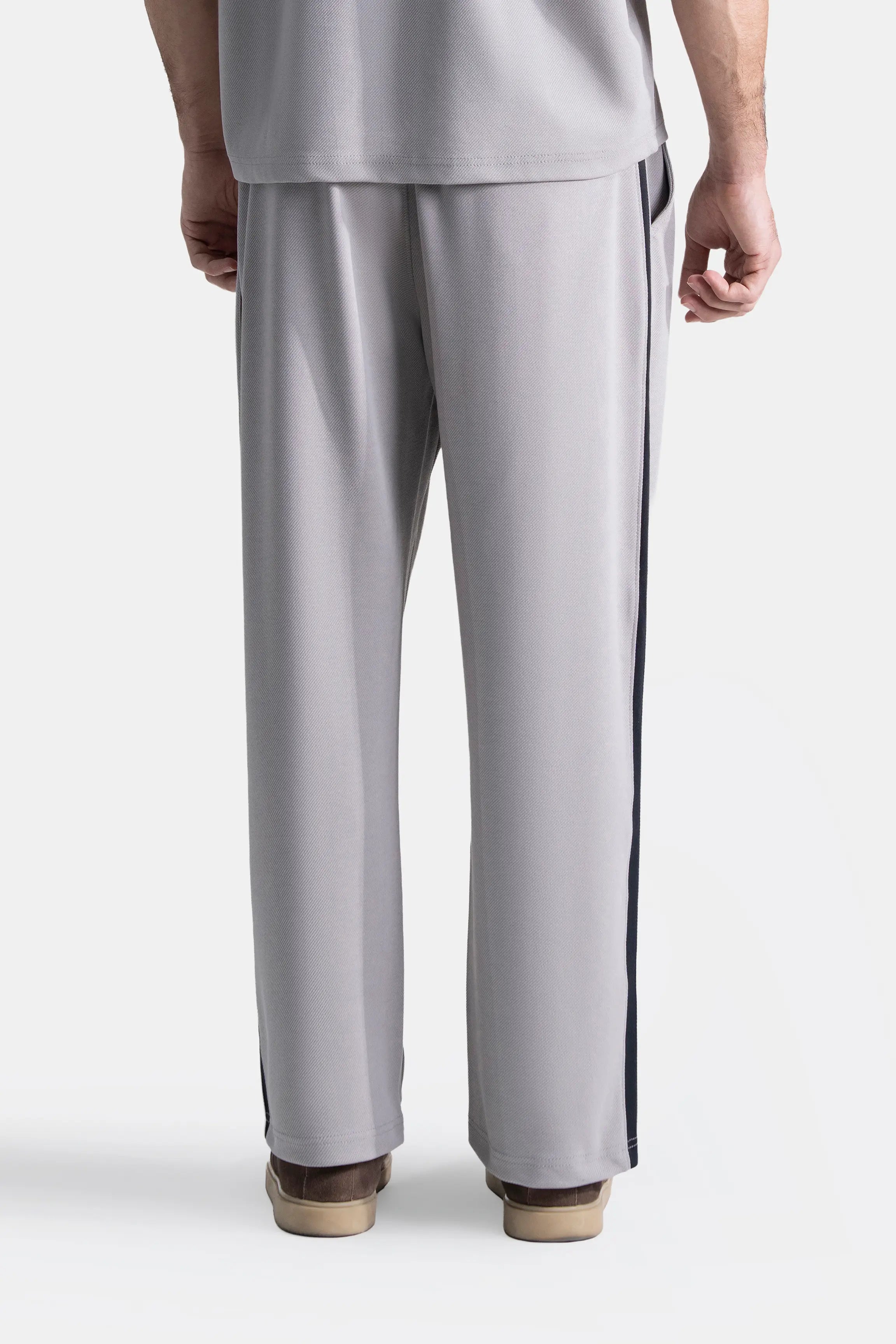 Grey loose-fit trousers with navy side stripe, straight leg and cuffed hem