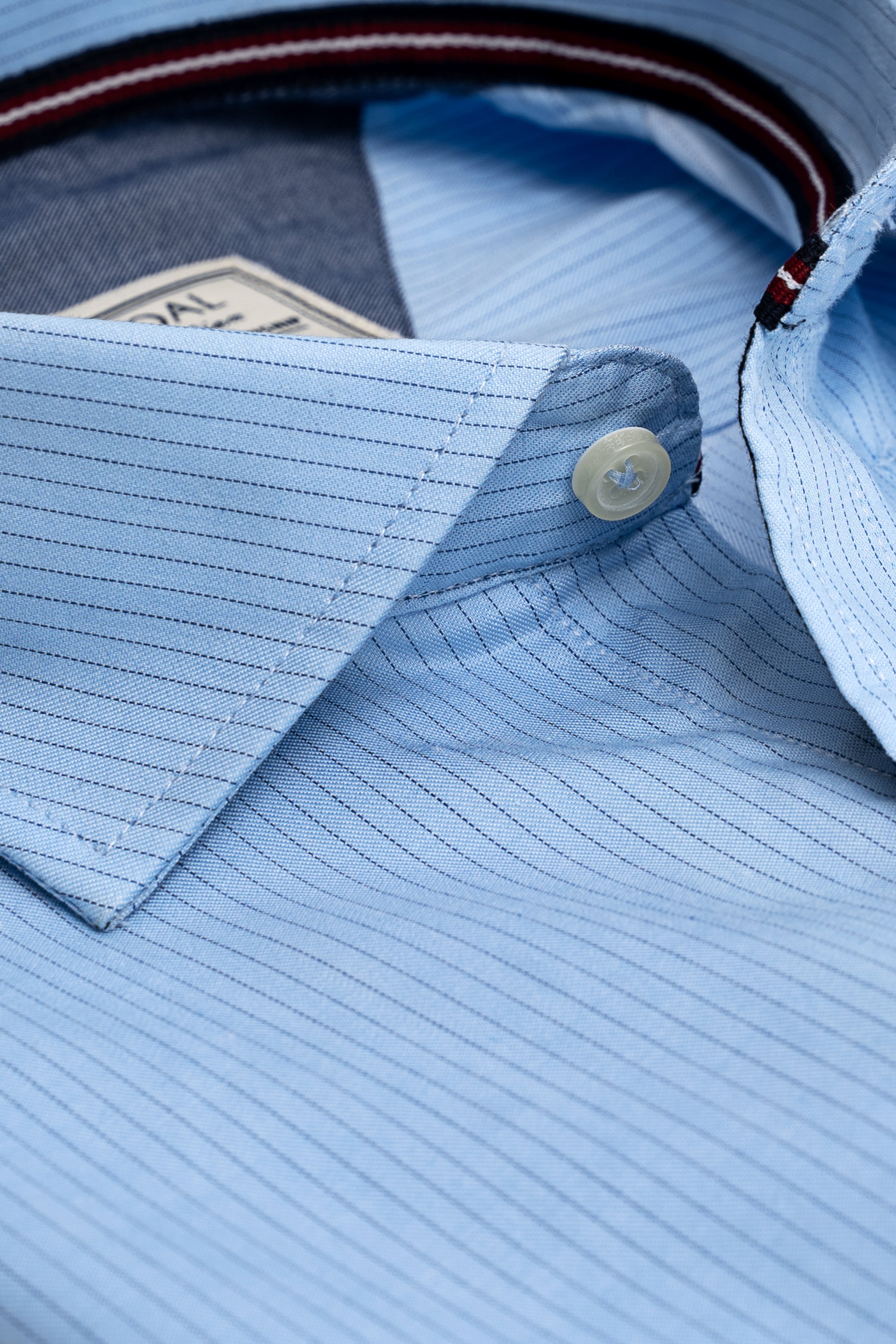 Sky blue striped dress shirt close-up of spread collar and button placket
