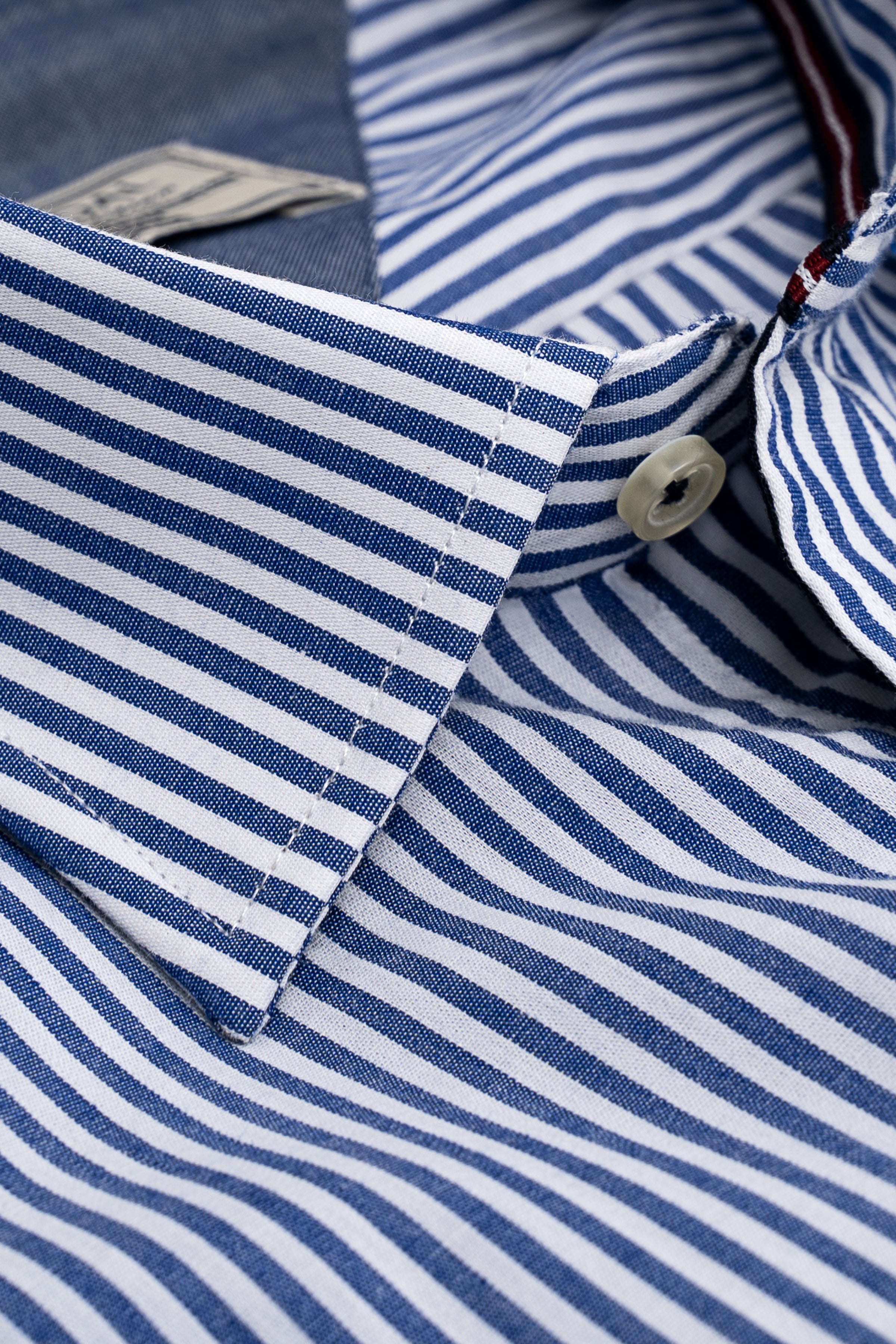 Striped dress shirt collar and placket with round button and white trim