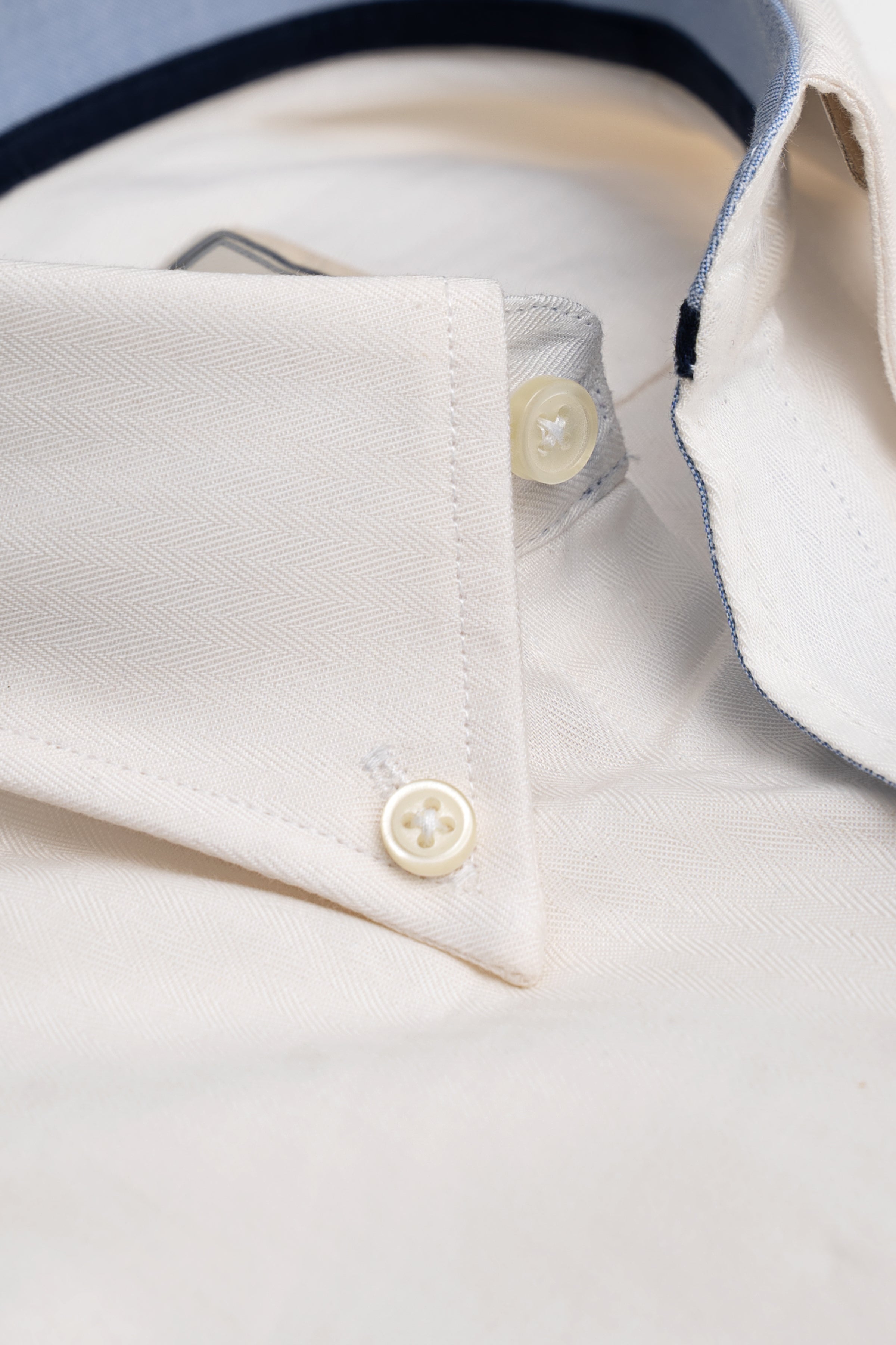 White shirt cuff and sleeve placket close-up with two buttons