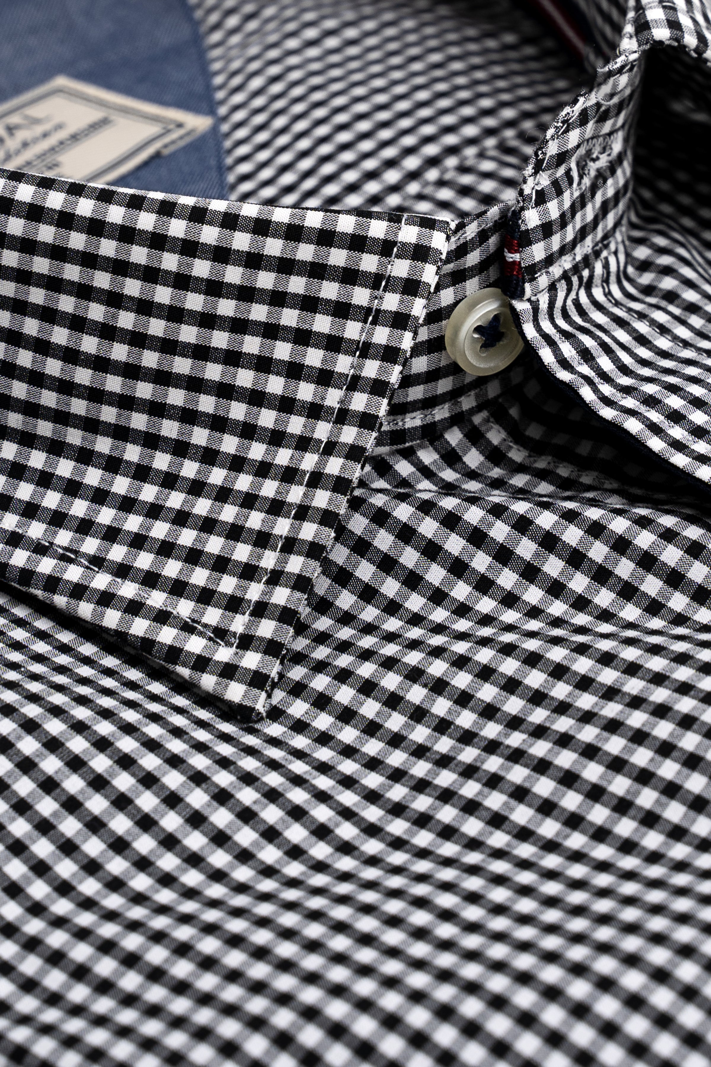 Black-and-white checked shirt sleeve and collar with button detail