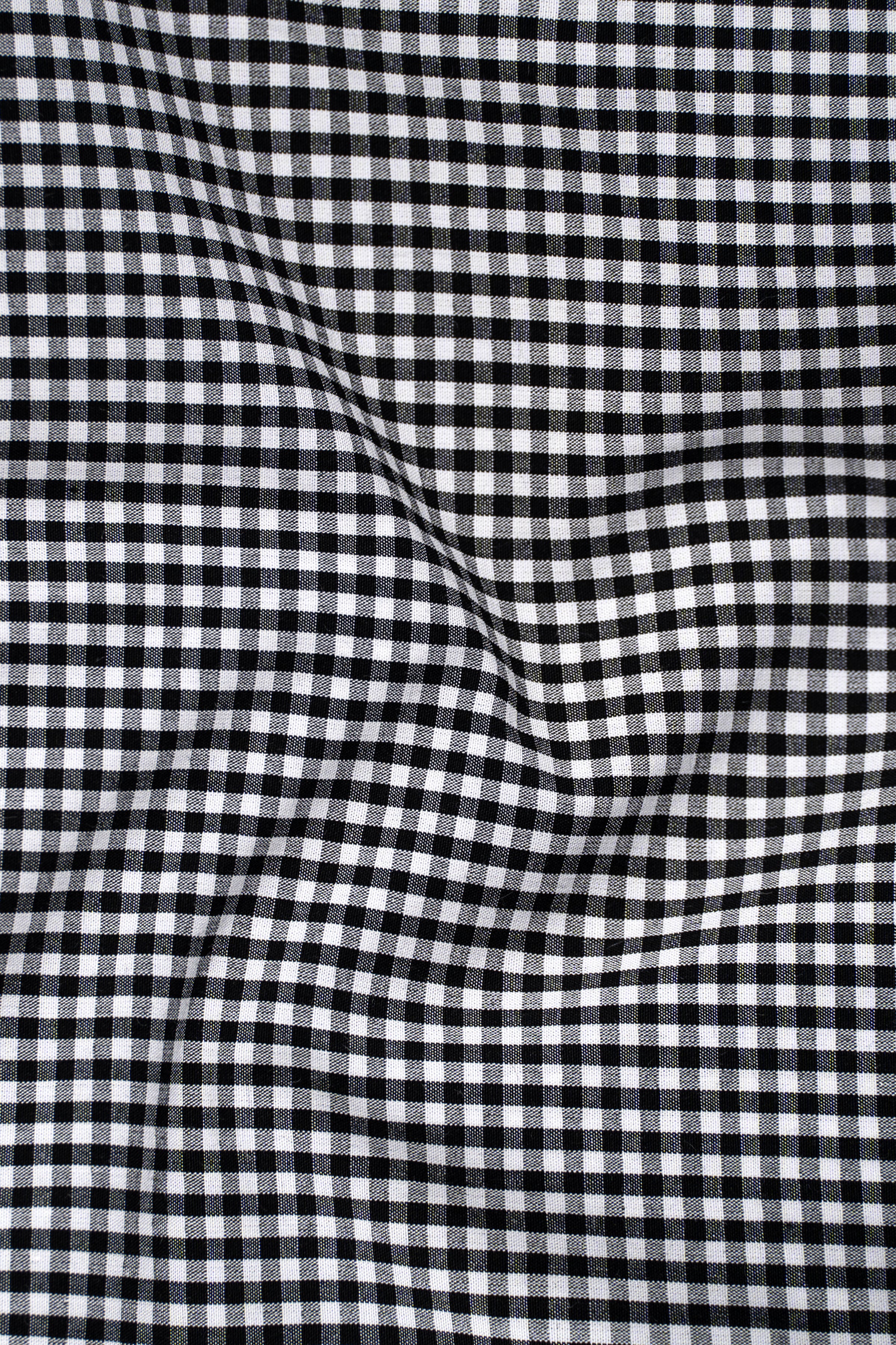 Black-and-white checked shirt fabric texture, close-up
