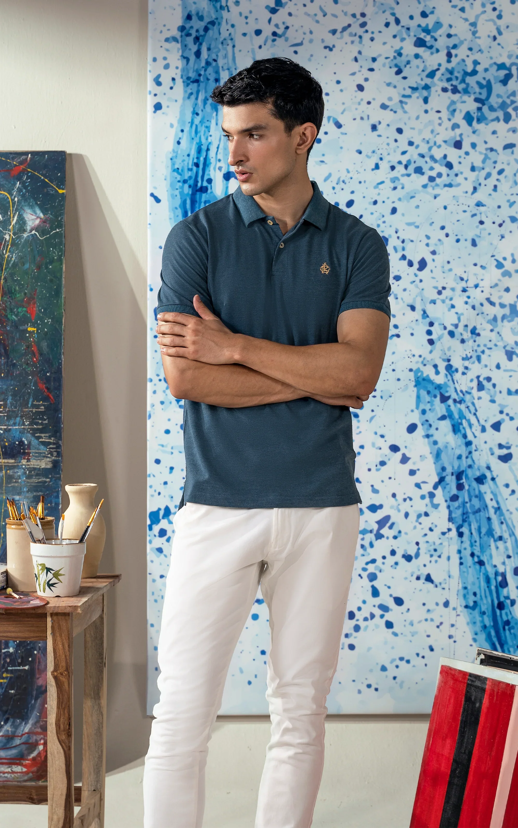 Teal blue polo shirt with short sleeves, collar, and button placket