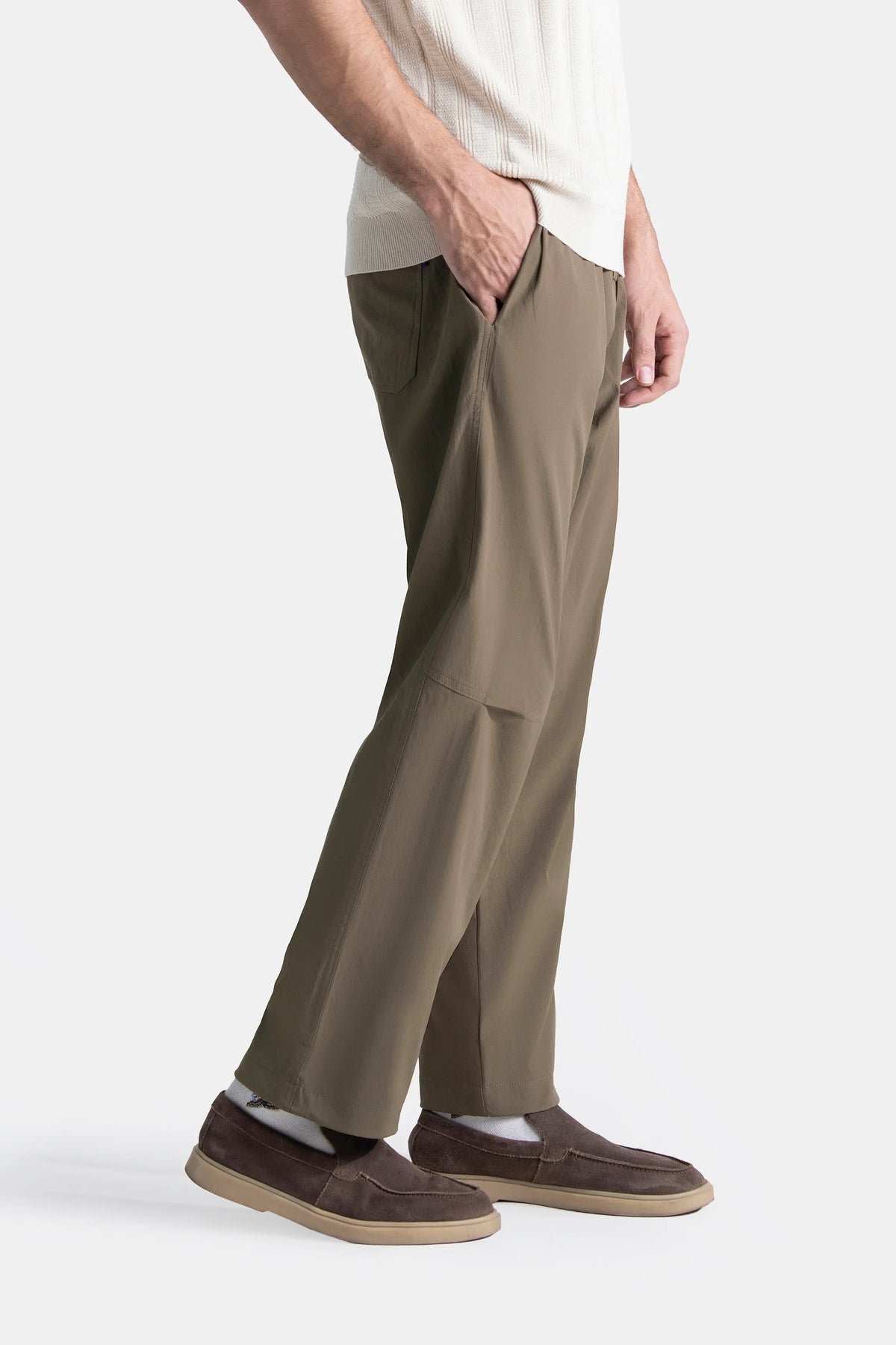 Olive loose-fit casual trousers shown from the side with relaxed straight legs