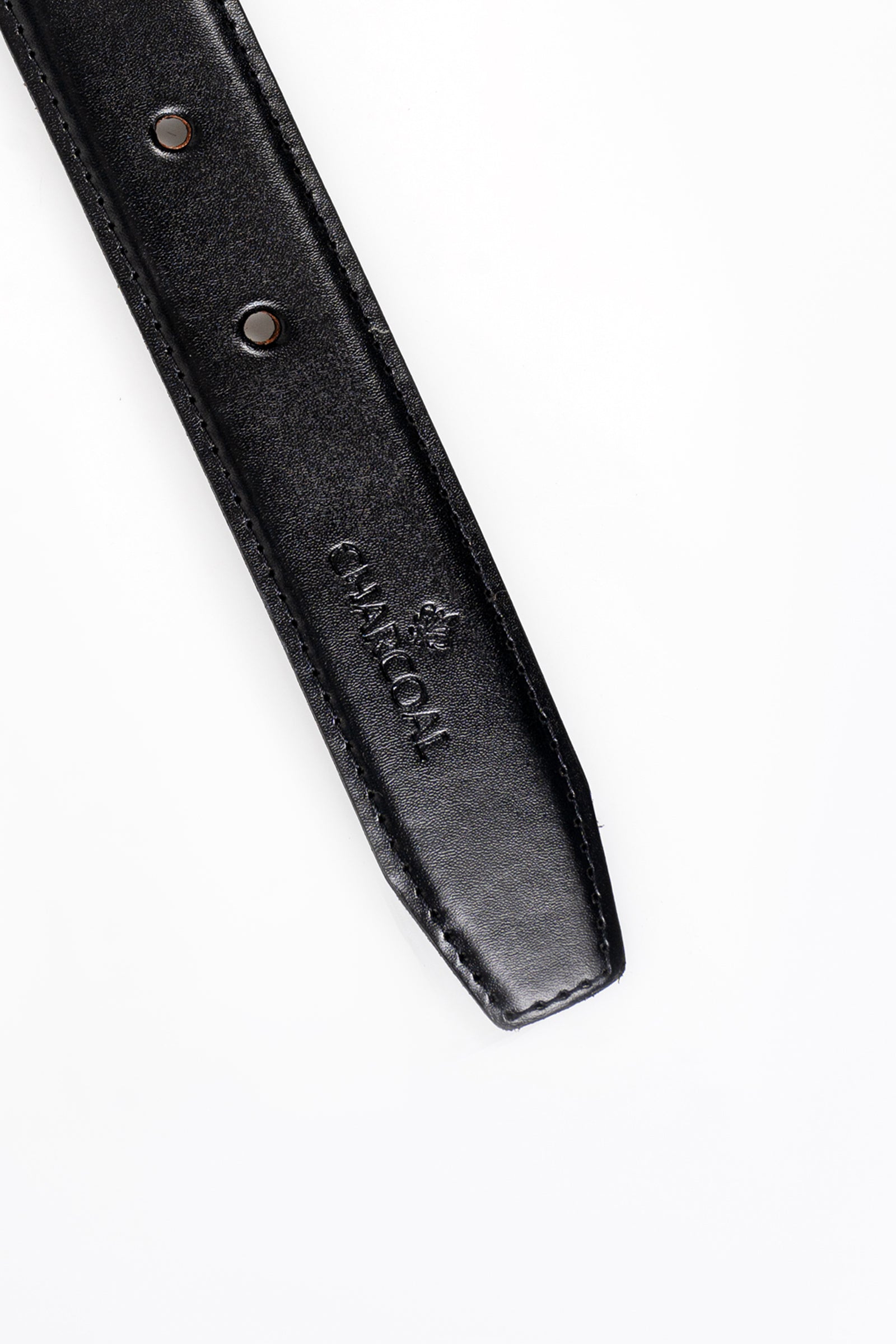 Black leather belt strap close-up with two rivet holes and embossed logo.