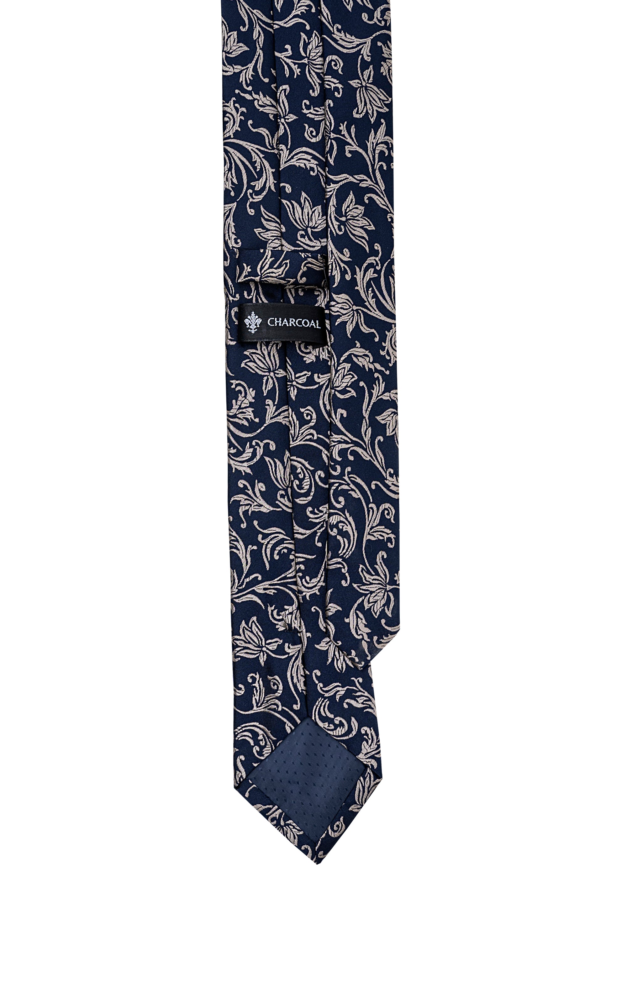 Poly silk tie with ornate scroll pattern and brand label on blade.