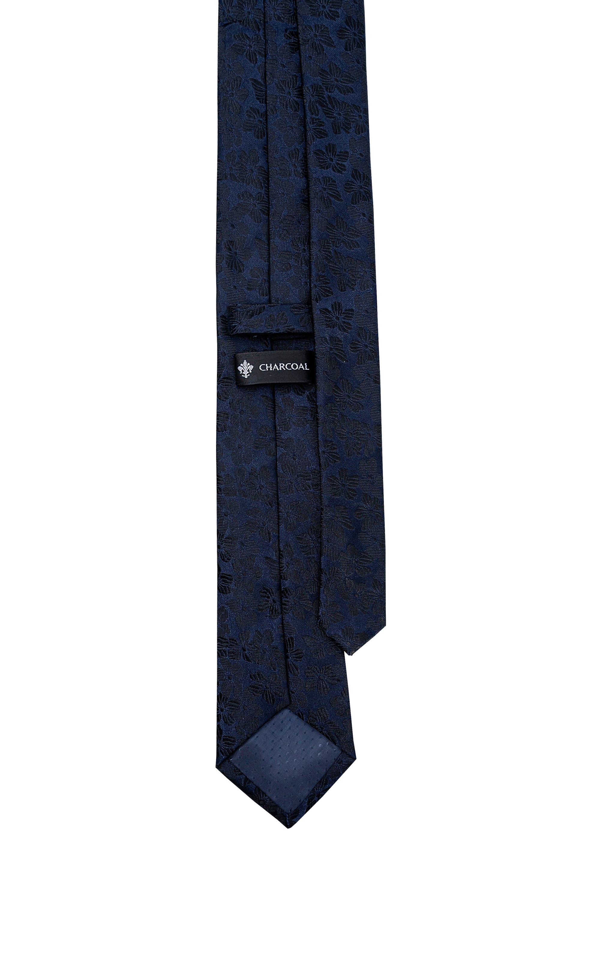 Silk tie in dark navy with floral pattern and small label near knot