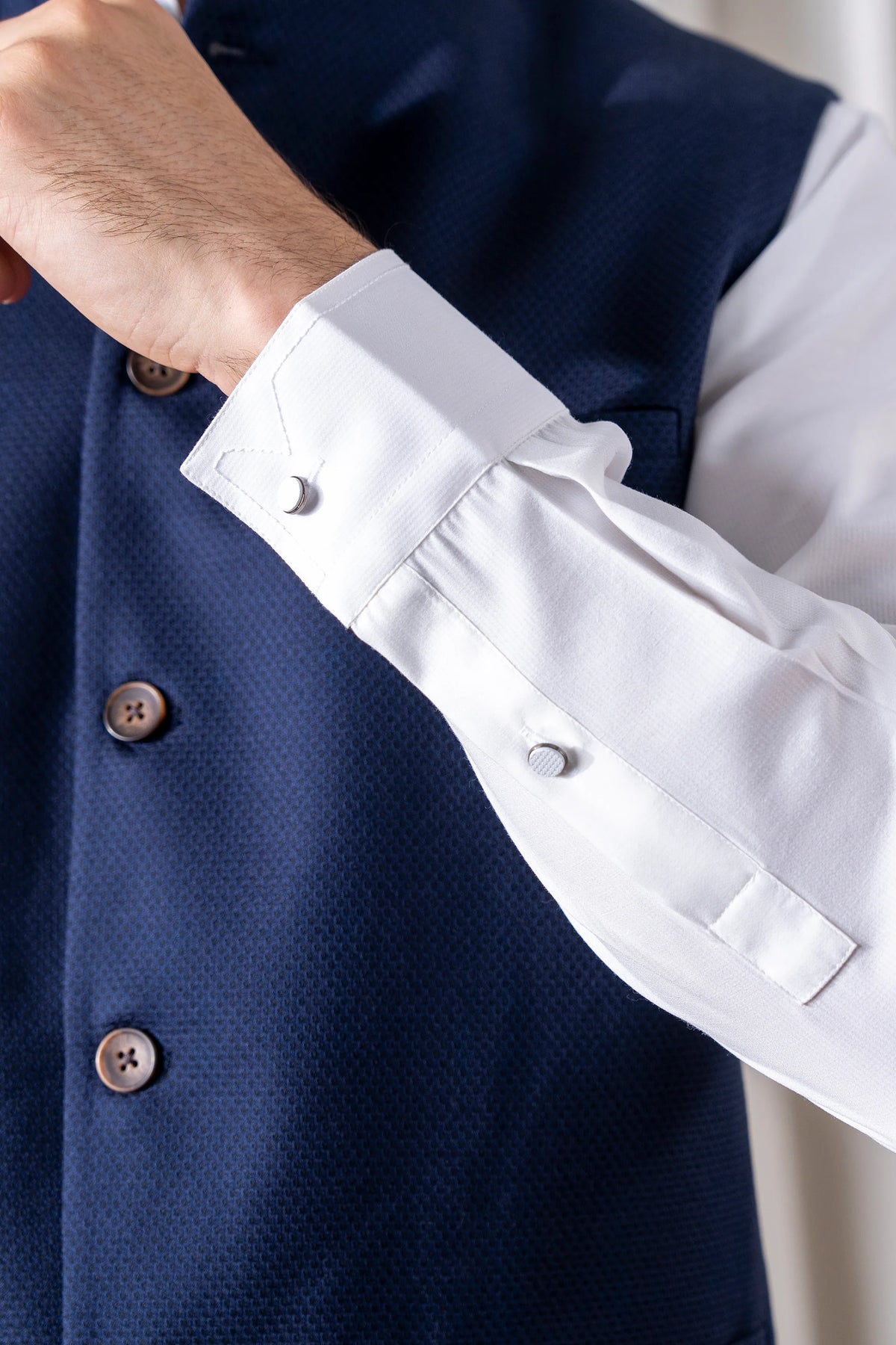 Navy cotton linen waistcoat detail with wooden-look buttons and pocket flap