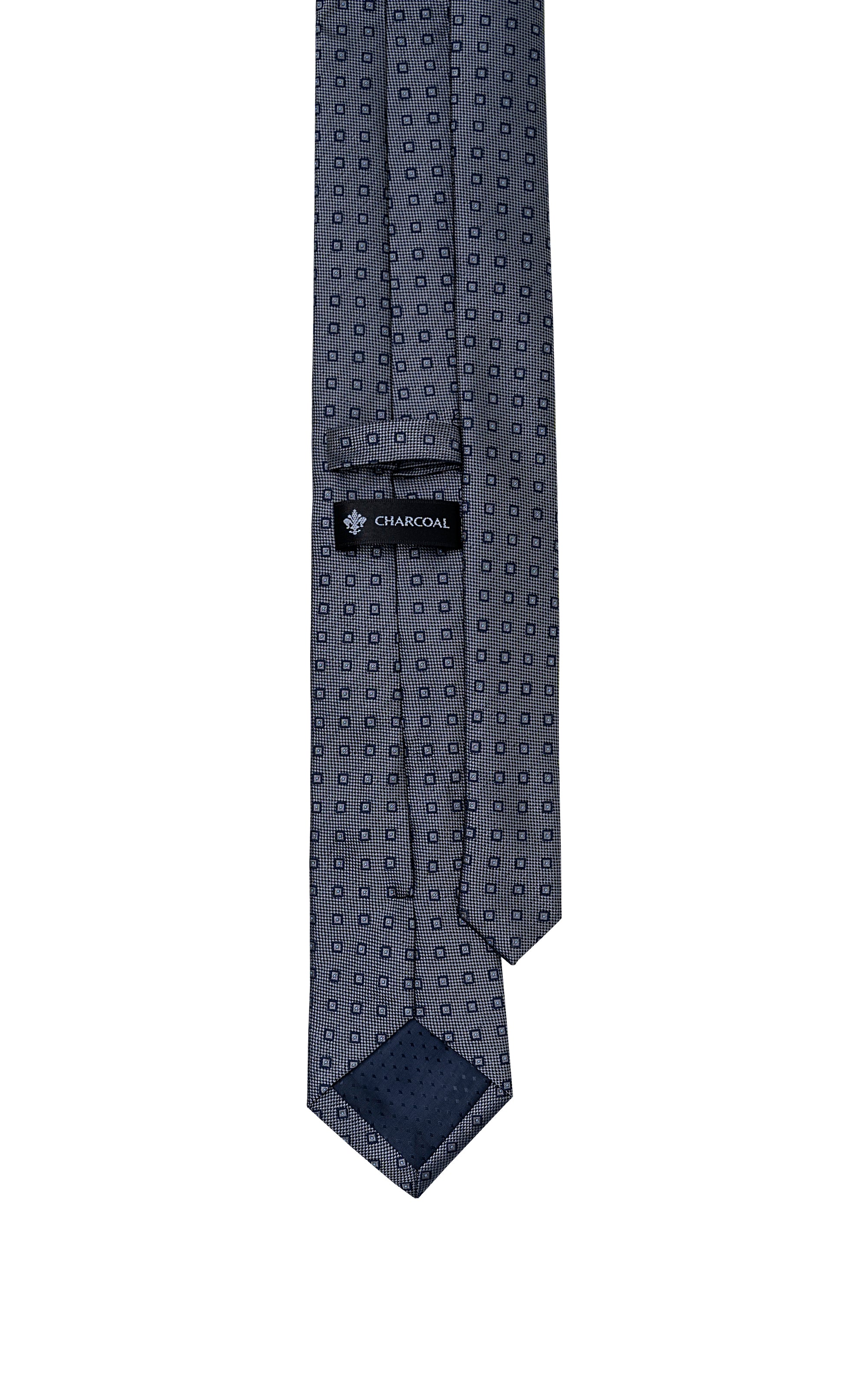 Navy poly silk tie with geometric dot pattern, keeper label near end