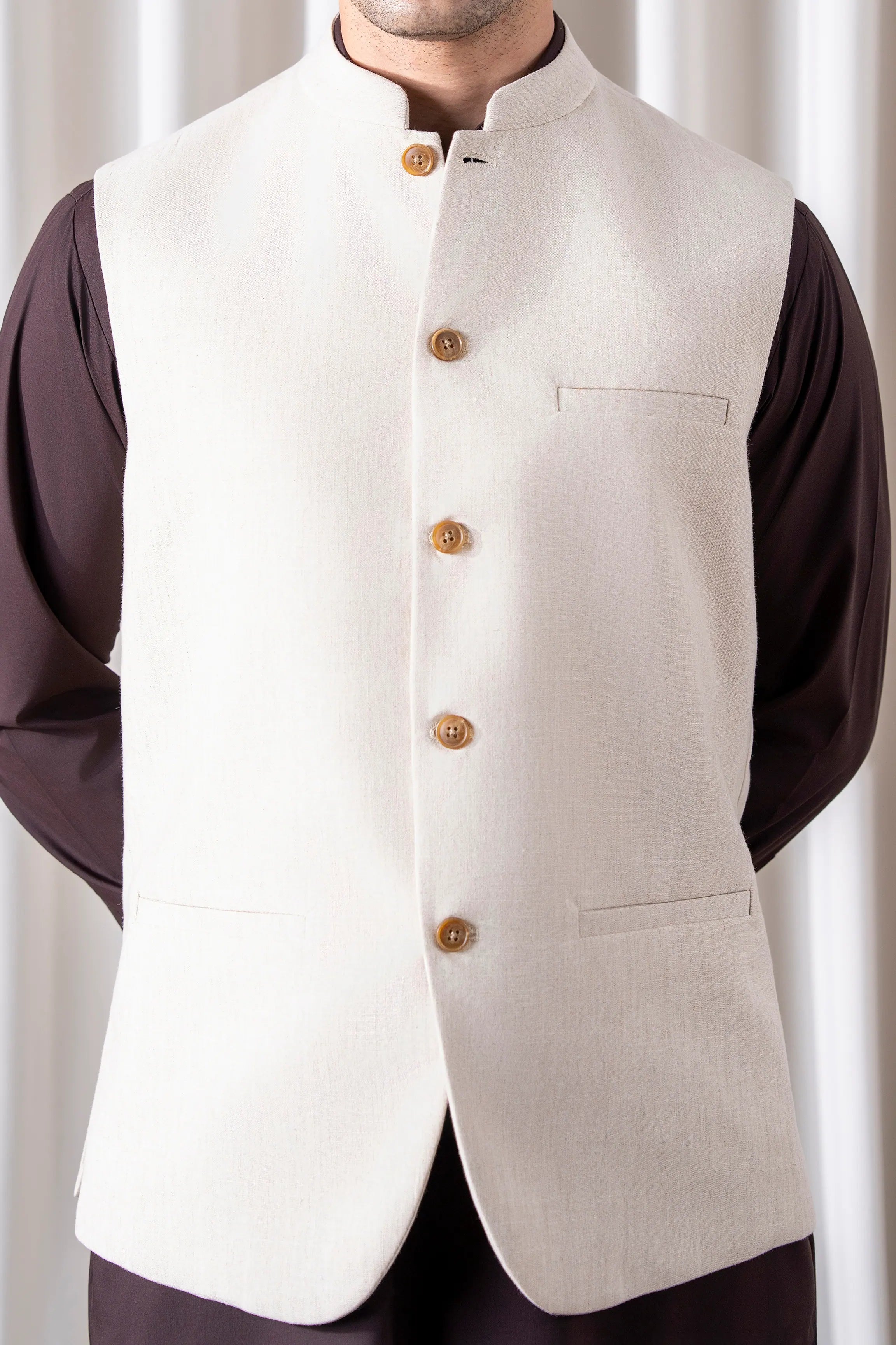 Cream waistcoat with stand collar, gold buttons, and chest patch pocket
