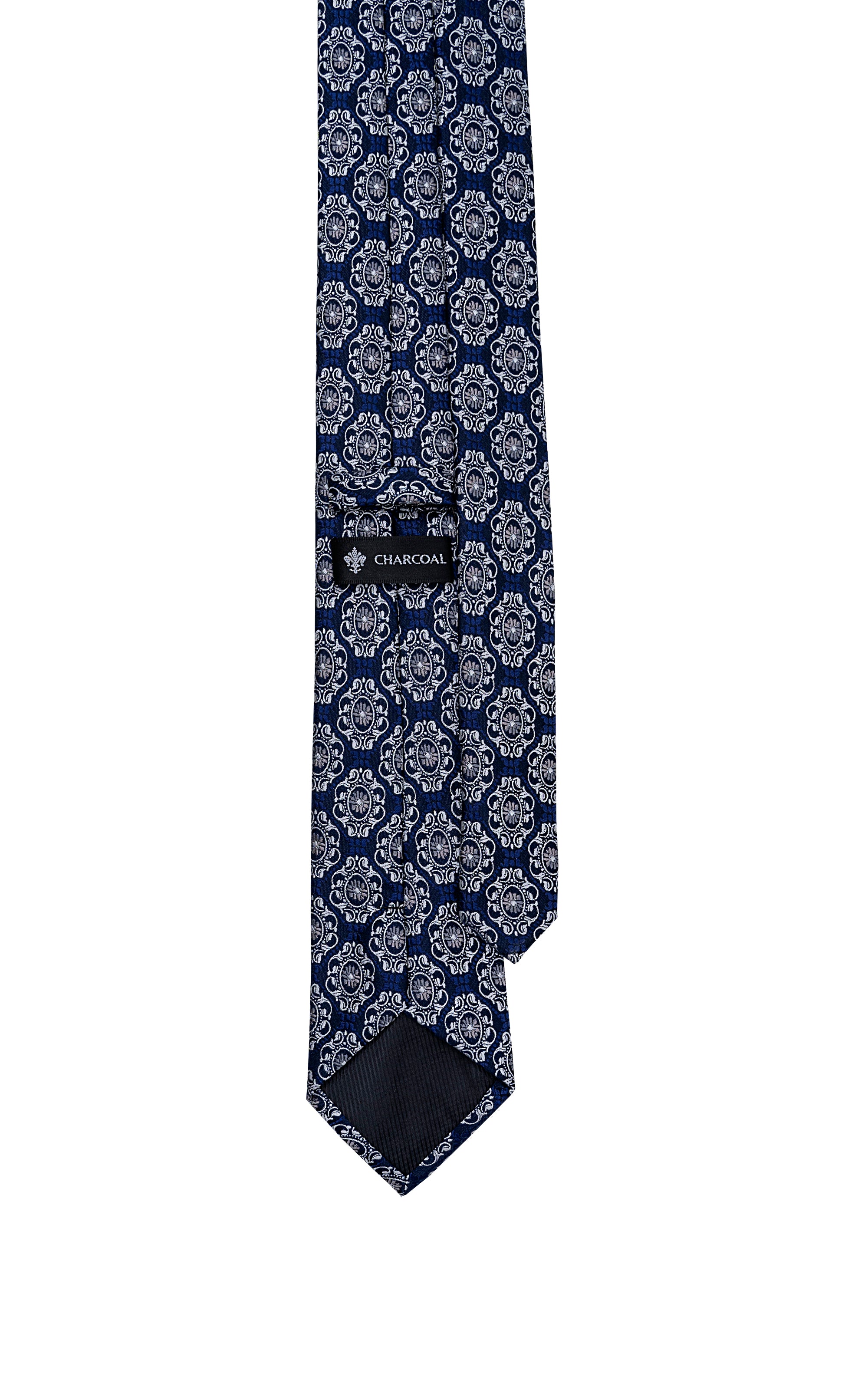 Navy blue patterned tie with repeating medallion circles and dark stitched hem