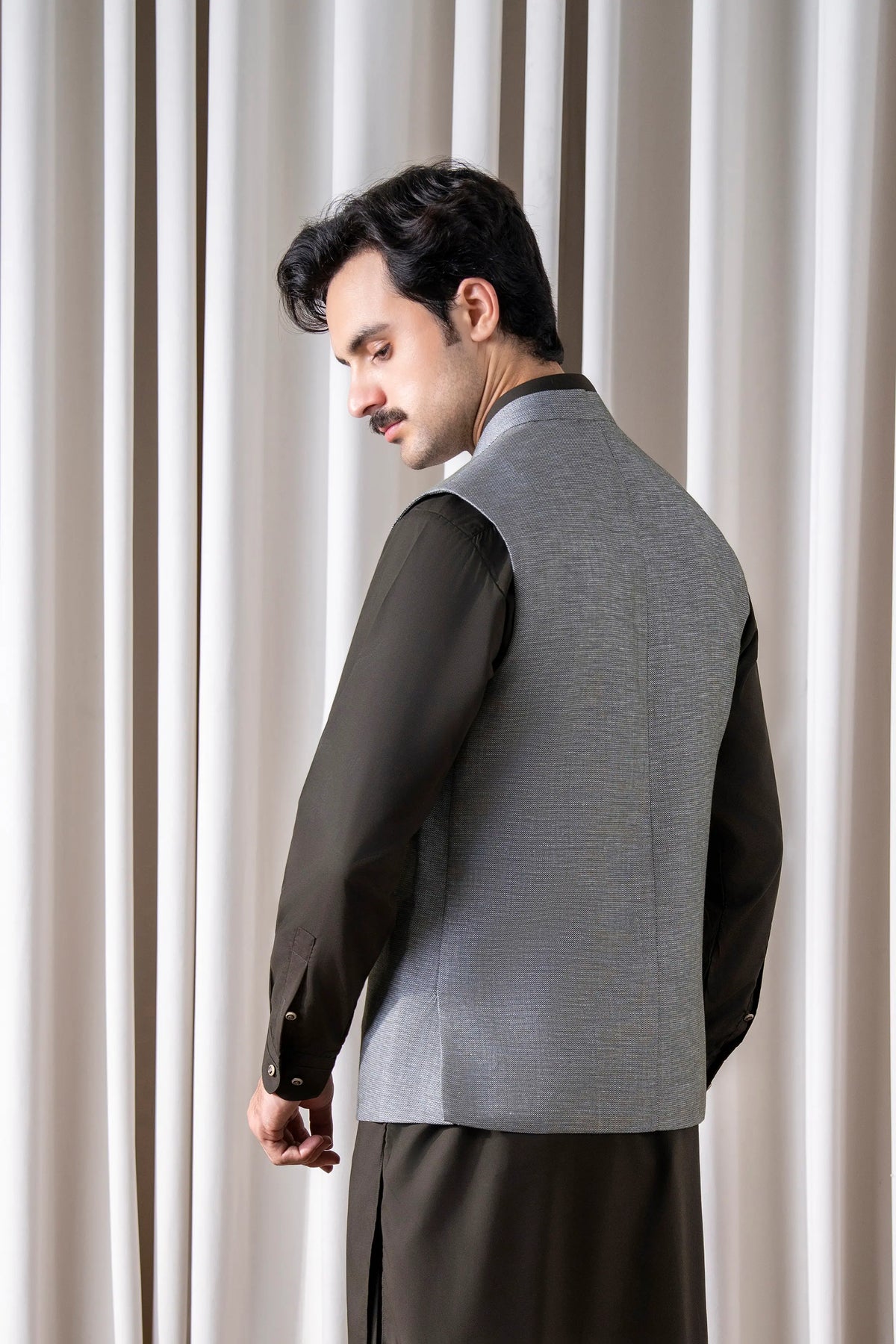 Gray cotton-linen waistcoat with dark side panel and button placket, side view