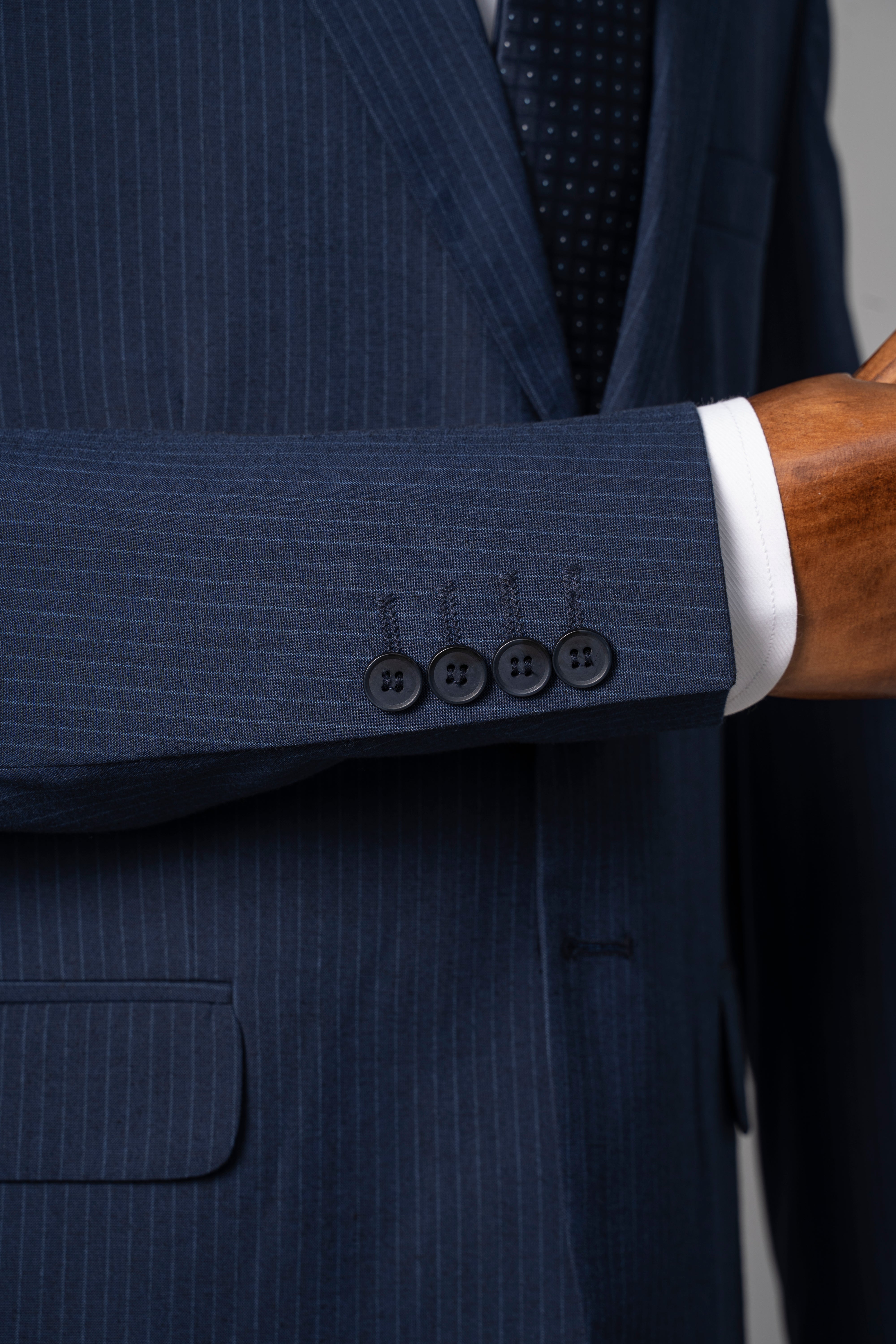 Navy pinstripe suit jacket cuff with four button detail