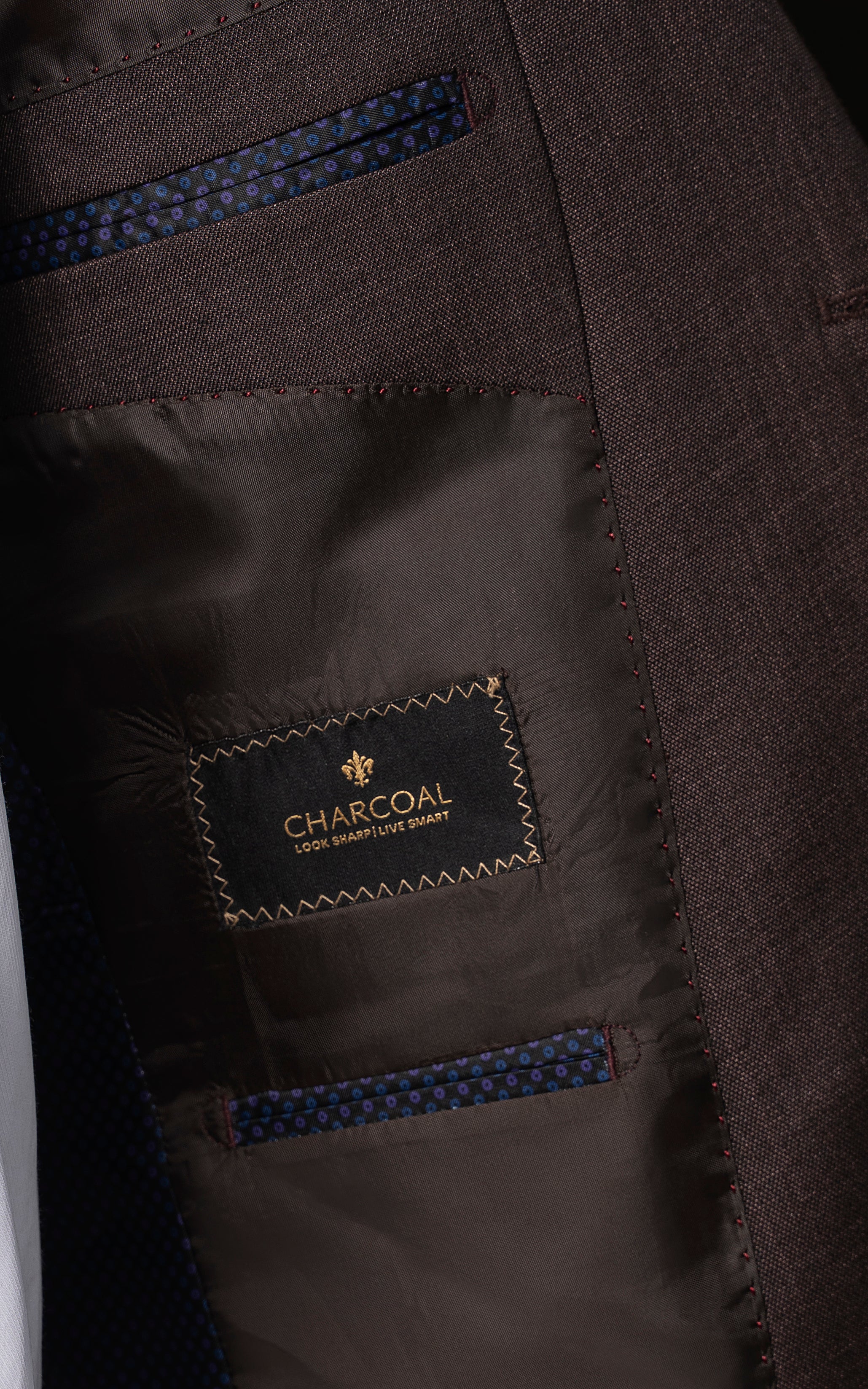 Brown suit lining with blue-patterned inner pocket and Charcoal label