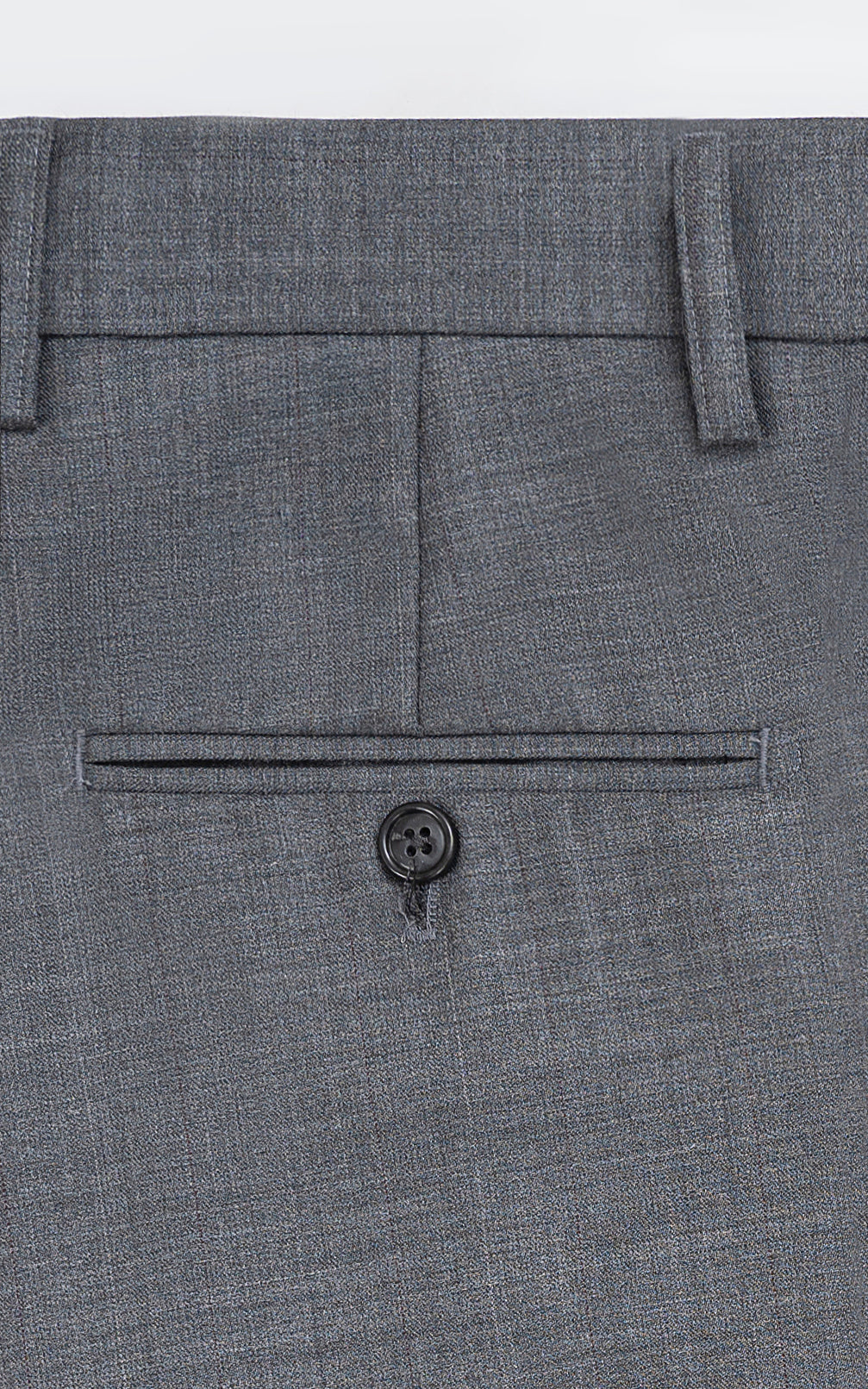 Grey dress pants front waistband and pocket with button closure
