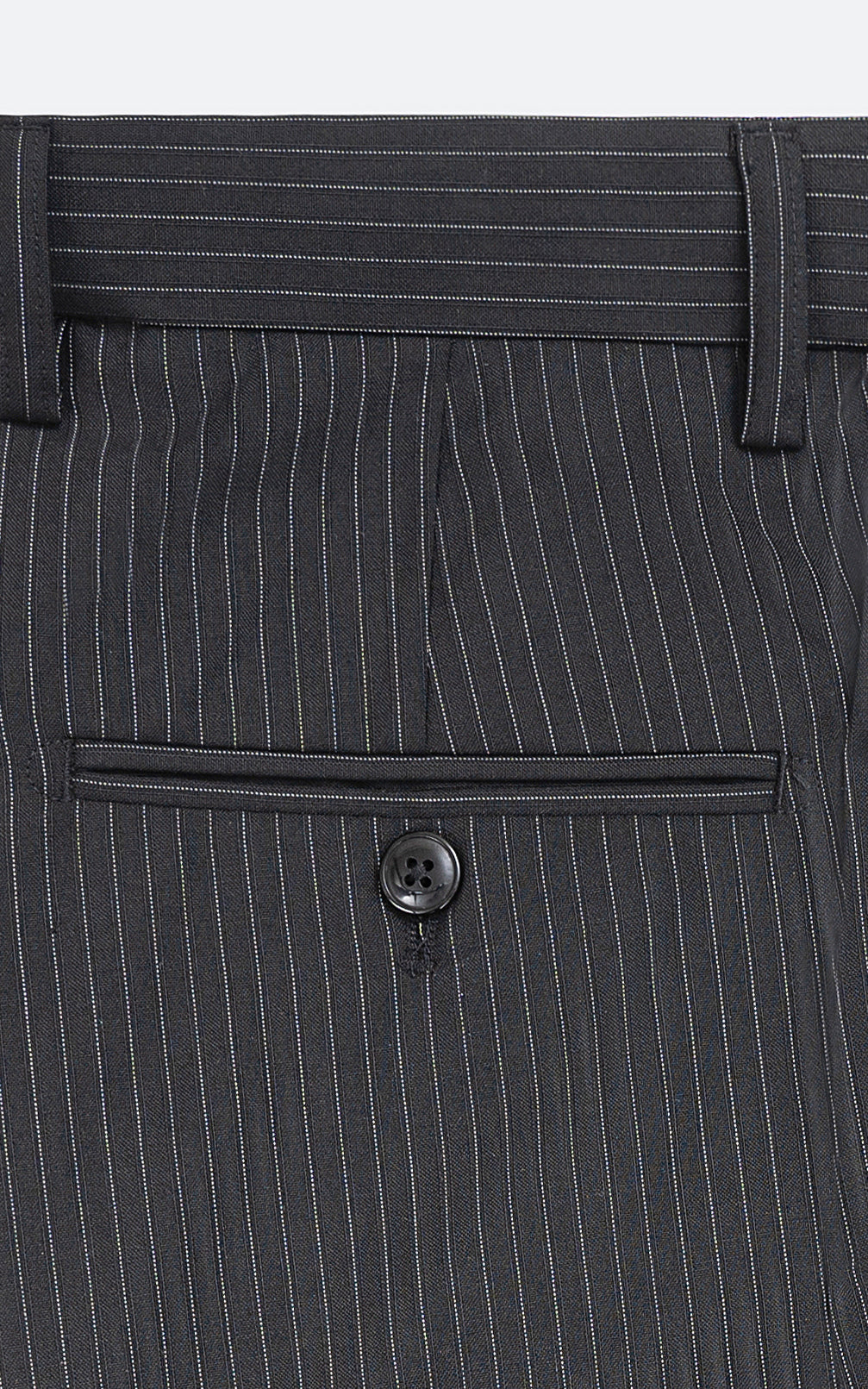Black pinstripe dress pants close-up of waistband, belt loops and front pocket