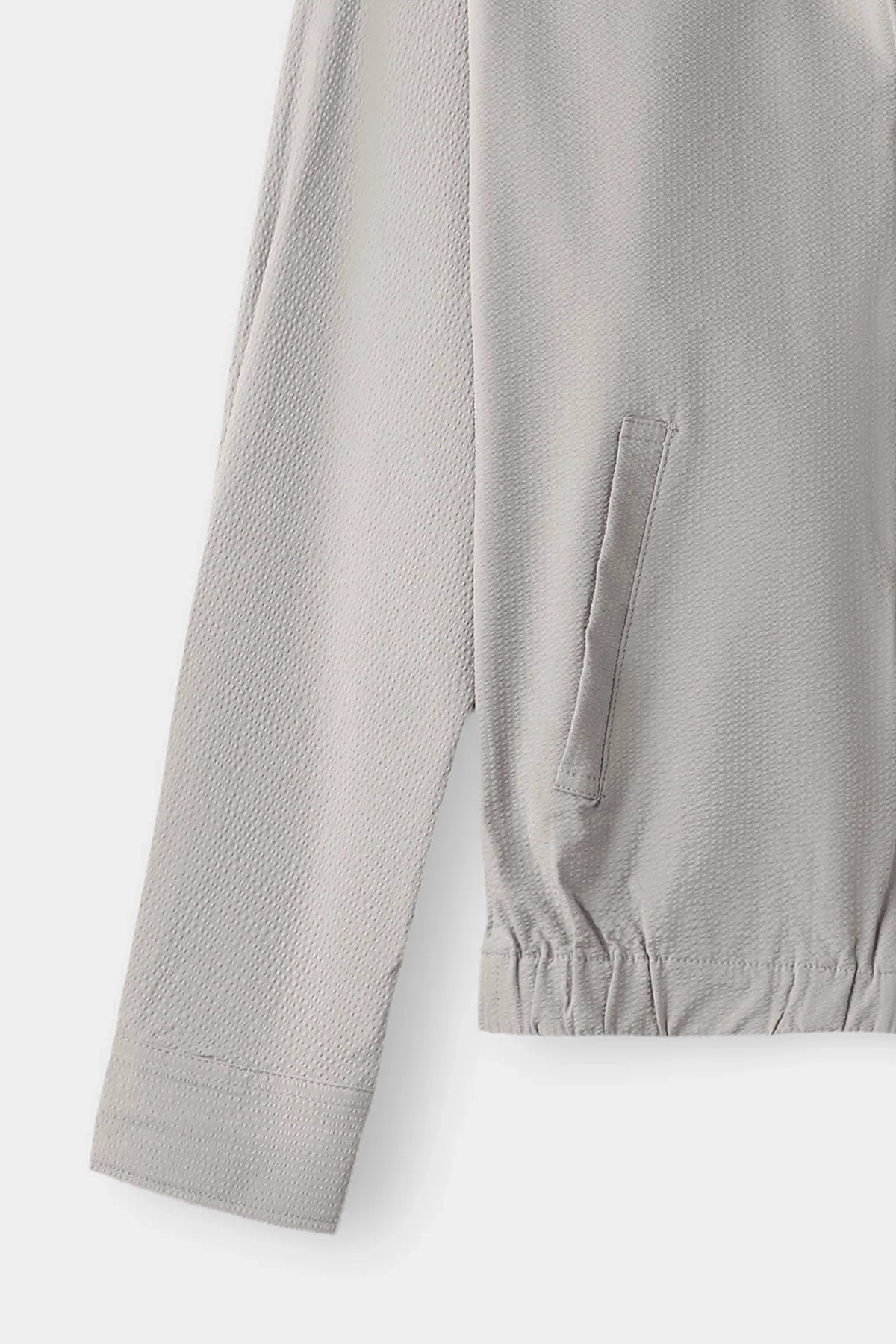 Seersucker jacket sleeve detail with elastic cuff and side seam panel.