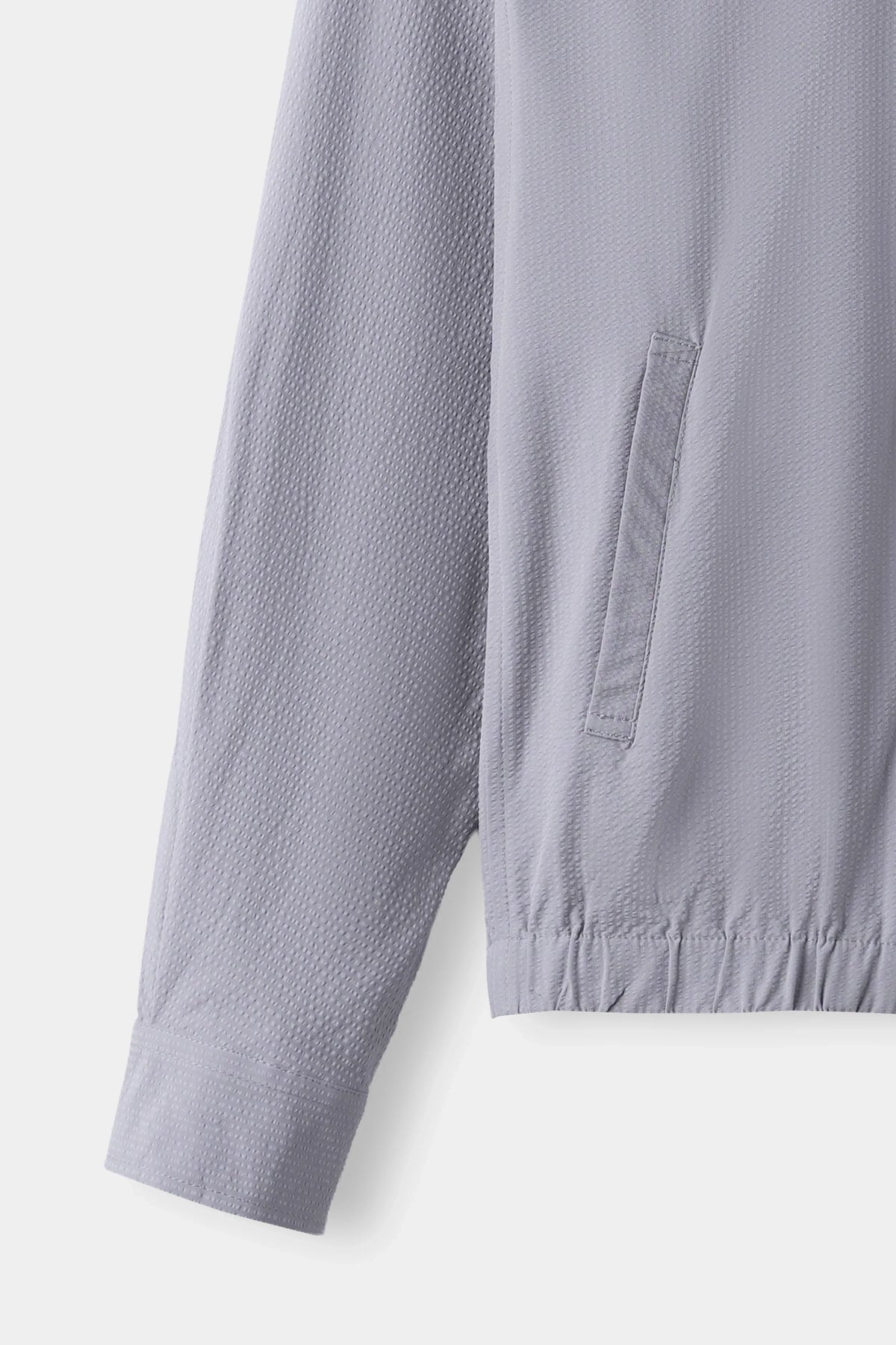 Light grey seersucker jacket with side pocket and elastic waist hem detail
