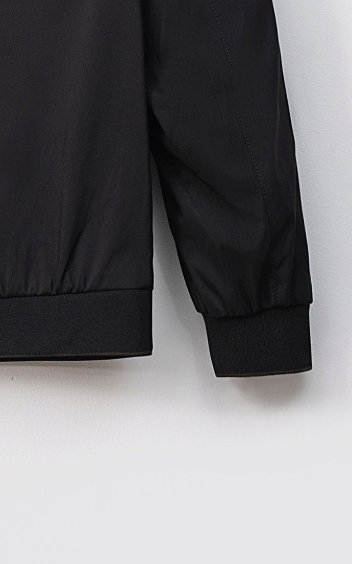 Lightweight men's black jacket sleeve detail with ribbed cuff and hem