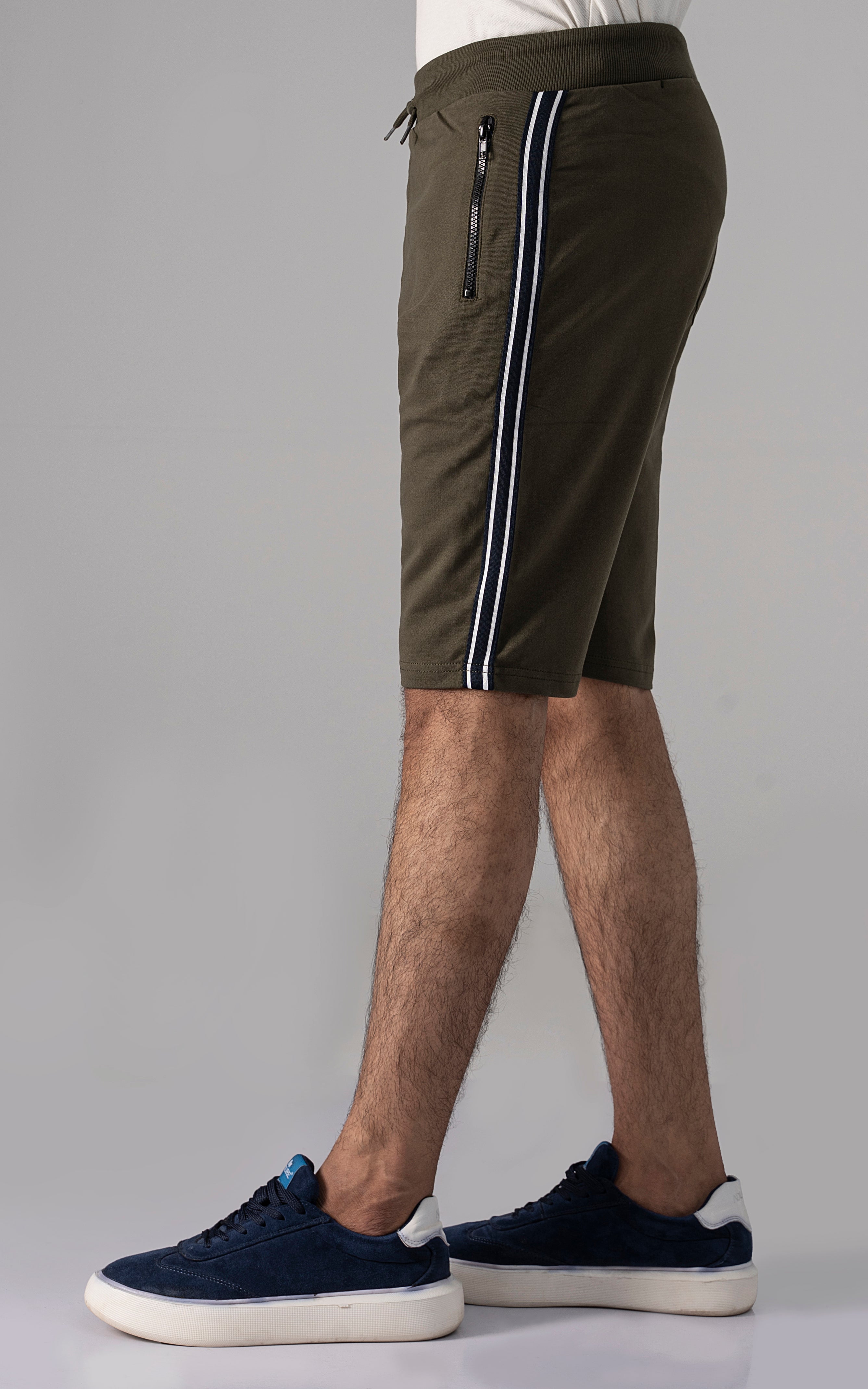 Olive casual shorts with drawstring, side stripe, zip pocket detail.