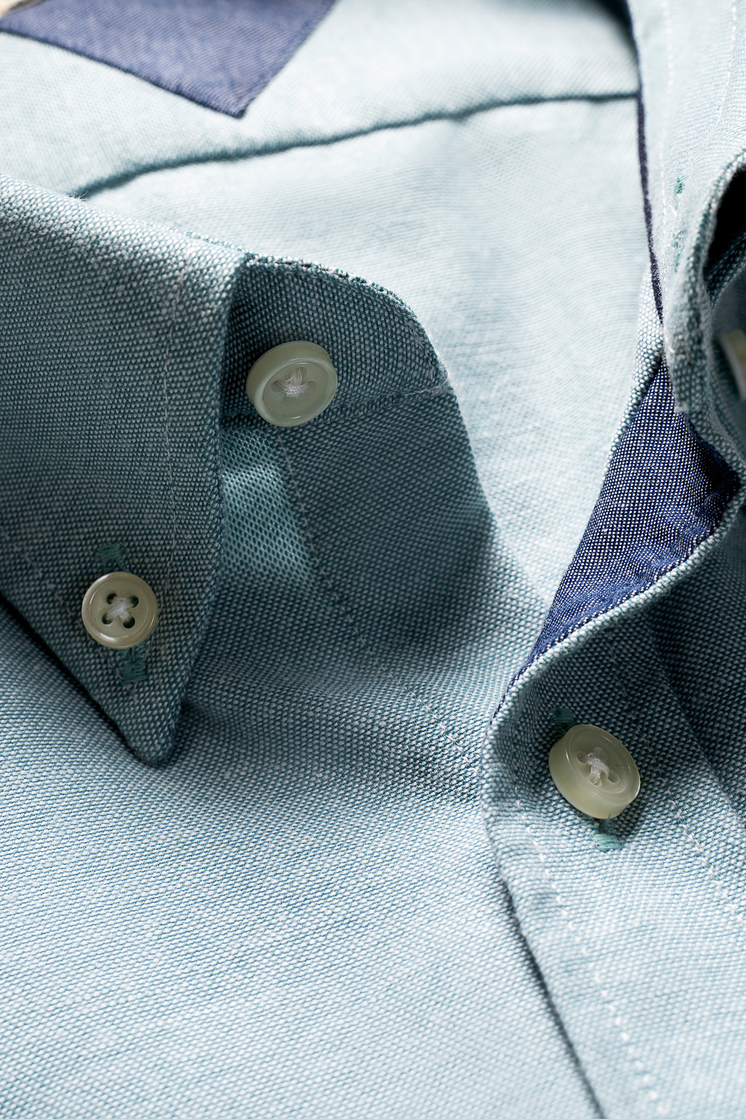 Limited edition light blue button-up shirt collar and button detail