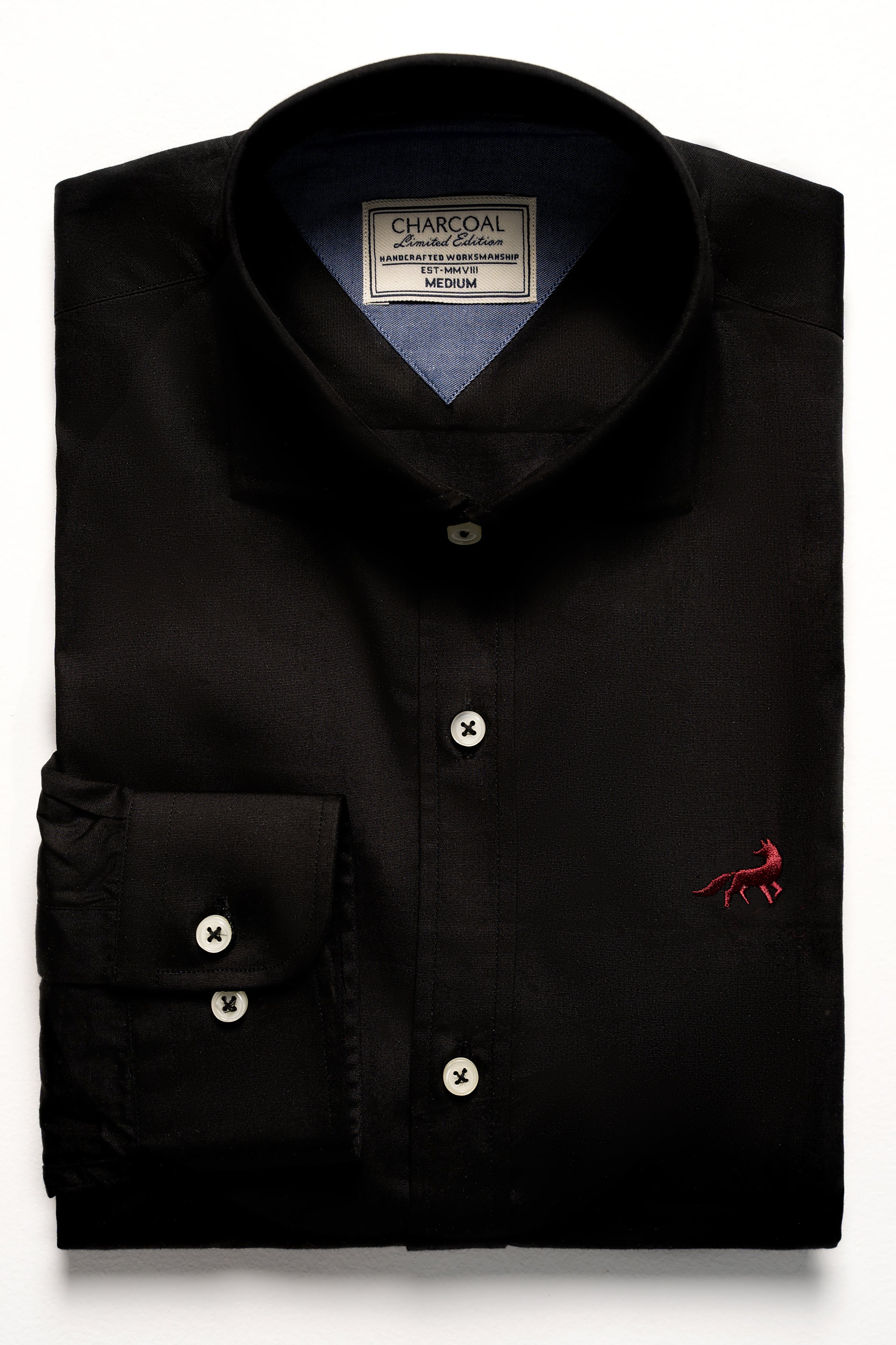 Limited edition black shirt with button placket and chest pocket, size label at neck