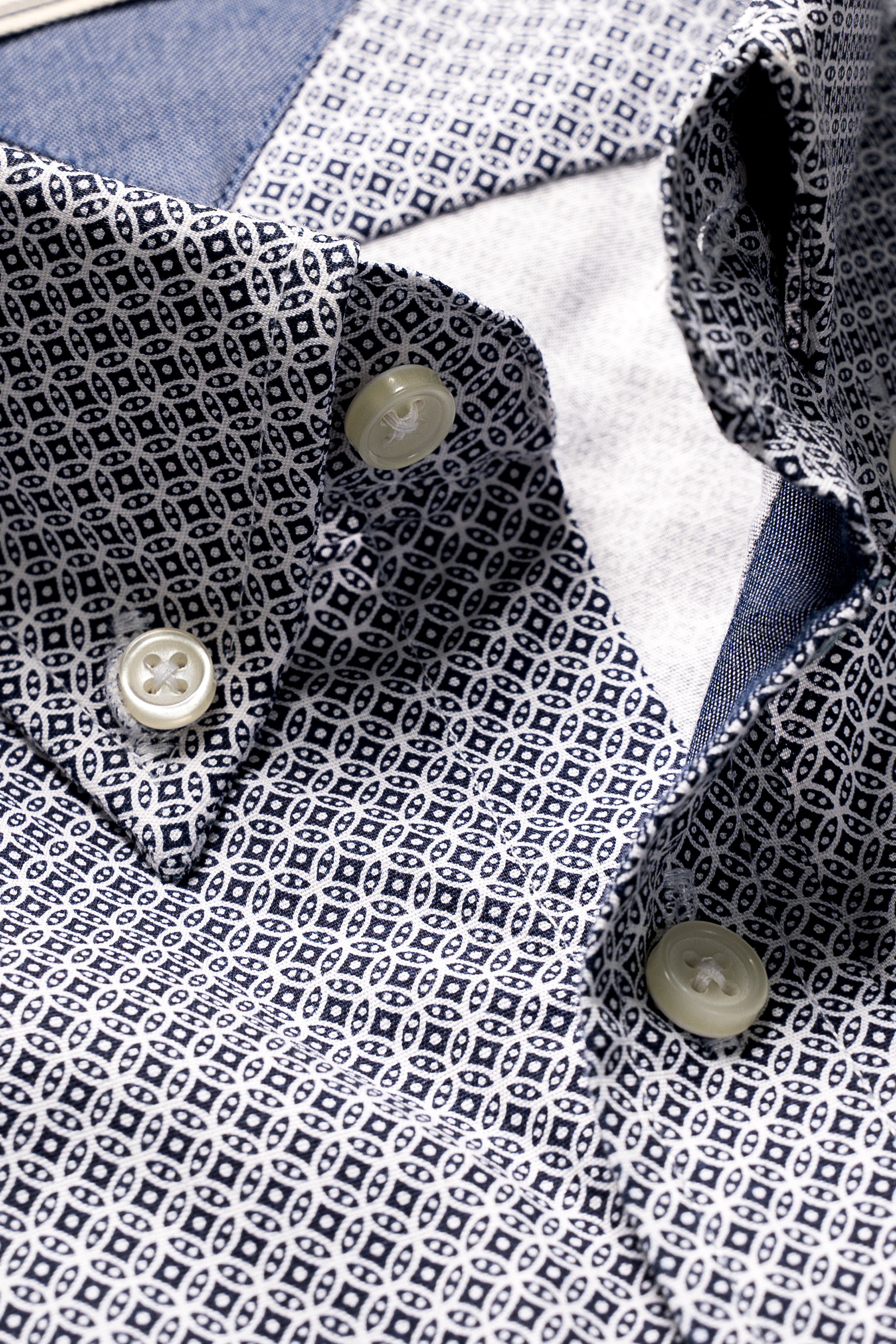 Men's dress shirt close-up, navy and white geometric print, button placket detail