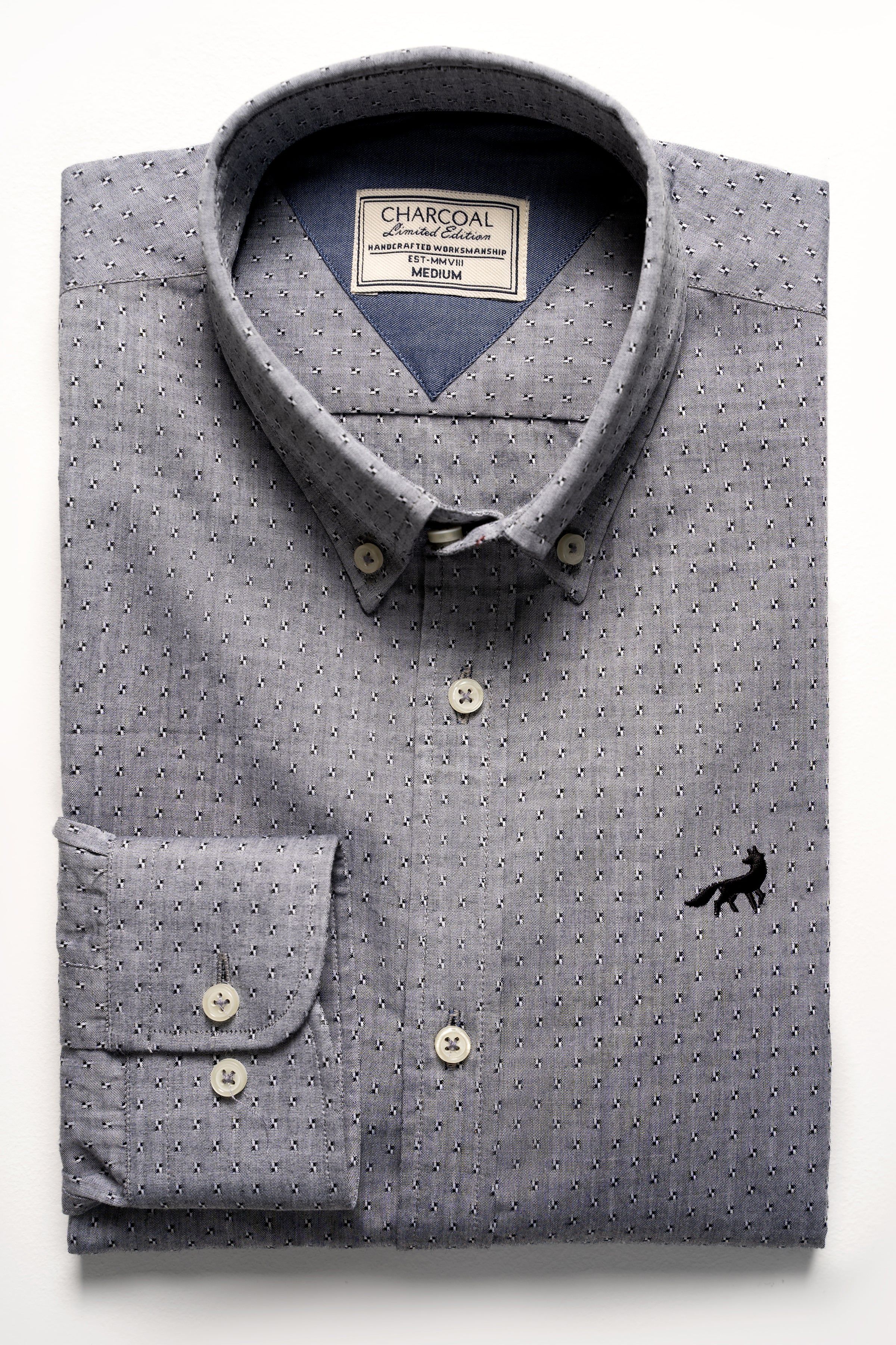 Grey patterned button-up shirt with dark buttons and pointed collar